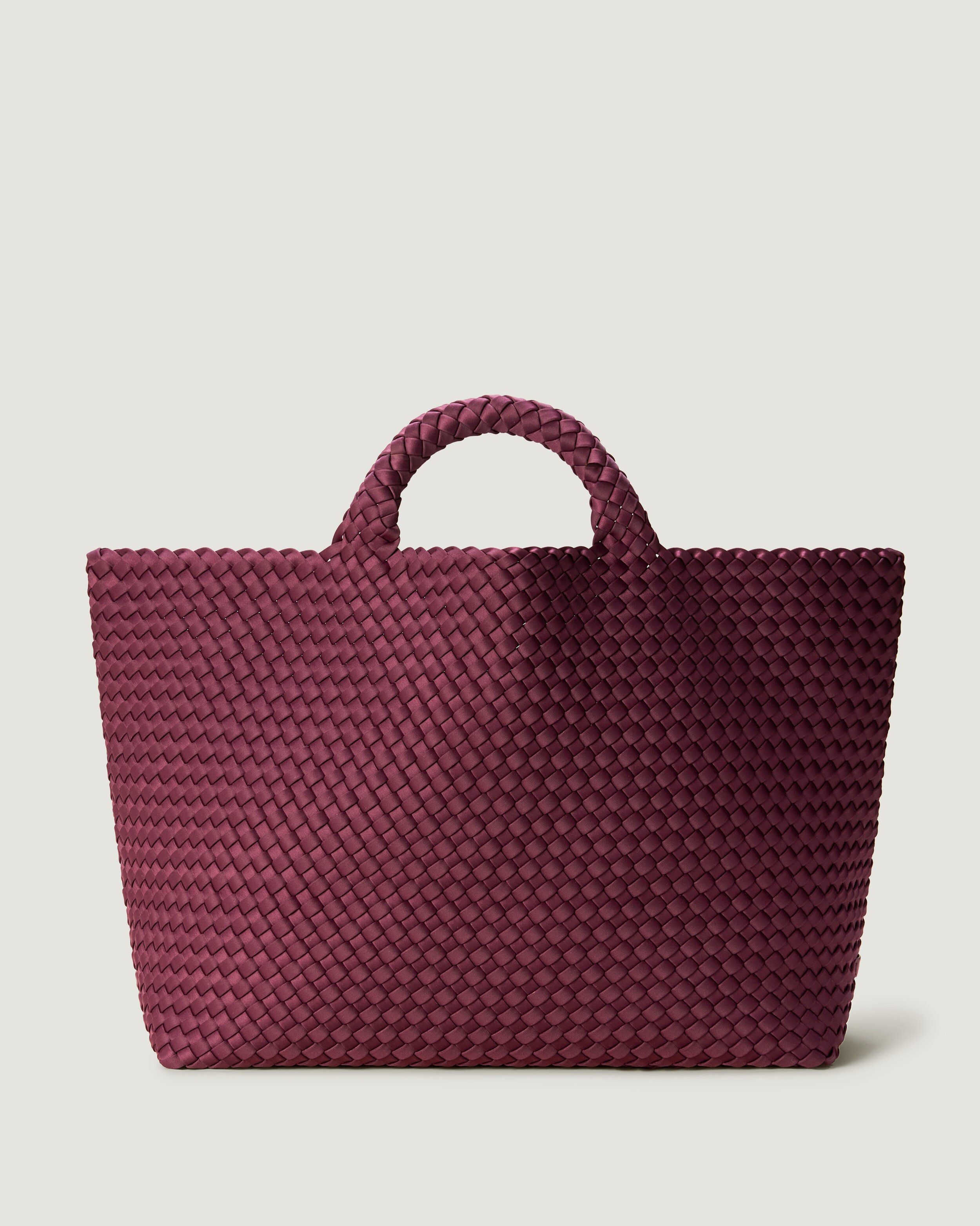 St. Barths Tote in Bordeaux, a rich burgundy tone, in handwoven neoprene, featuring an open top, and woven top handles.