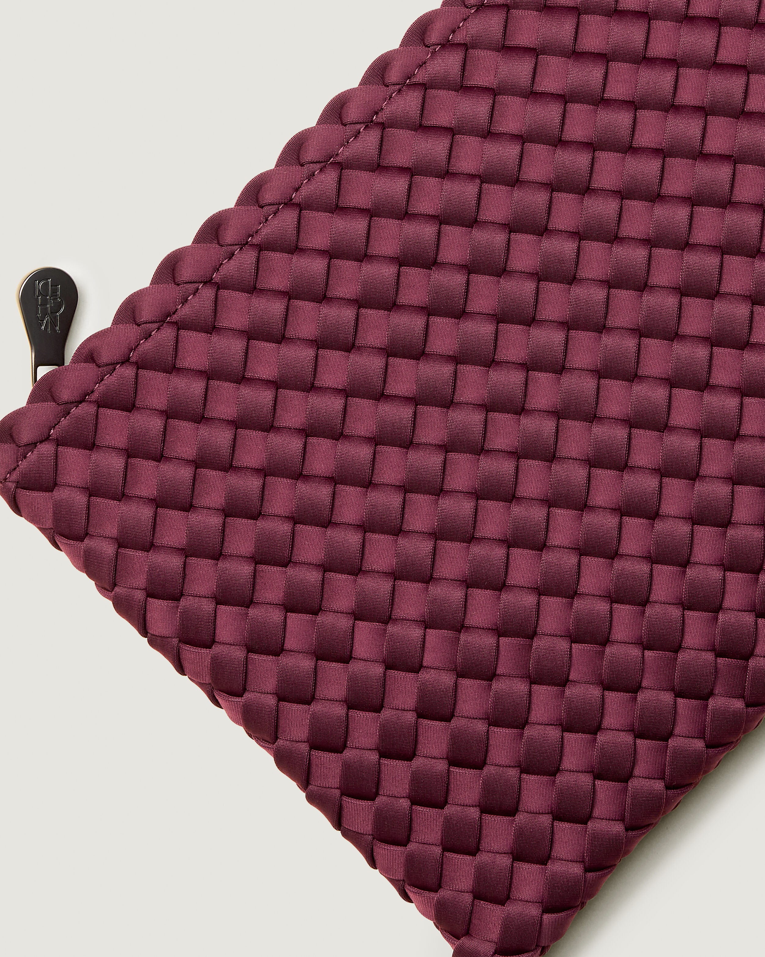 Close-up of included matching woven zippered pouch.