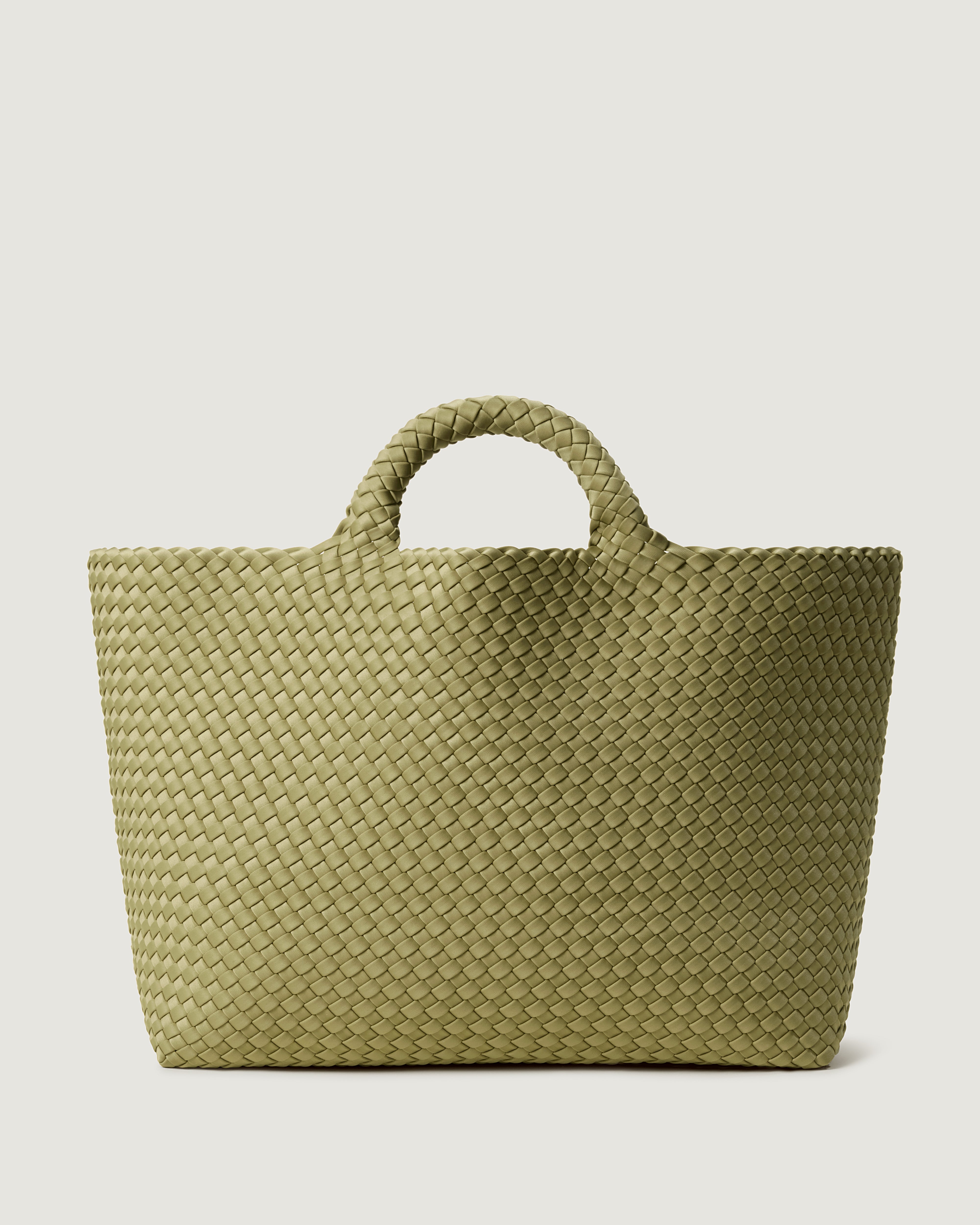 St. Barths Tote in Bottle Green, handwoven in muted green neoprene. Featuring an open top, and woven top handles.