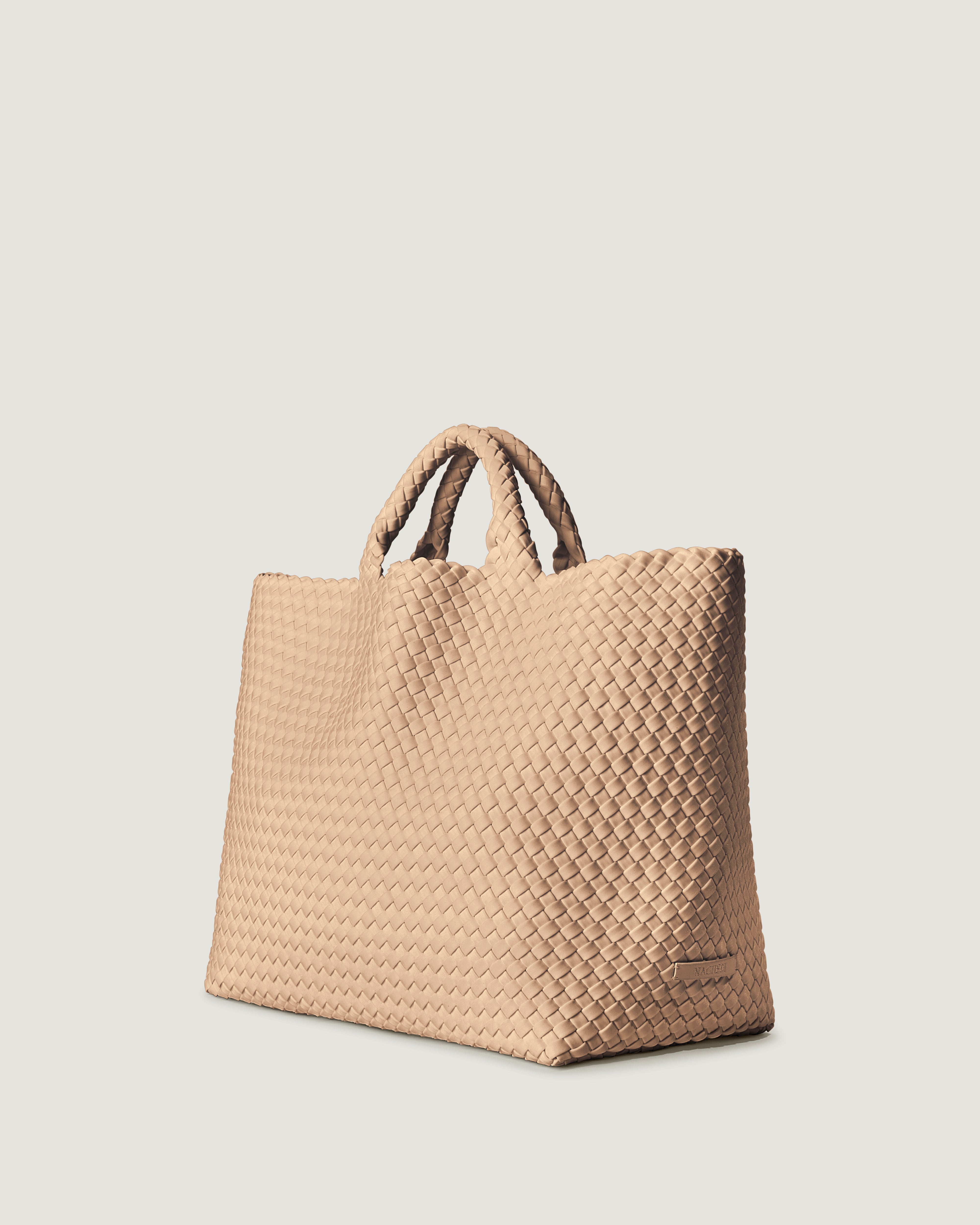 St Barths Tote in Camel shown from a side angle, highlighting its handwoven neoprene construction and open top with magnetic snap closure.