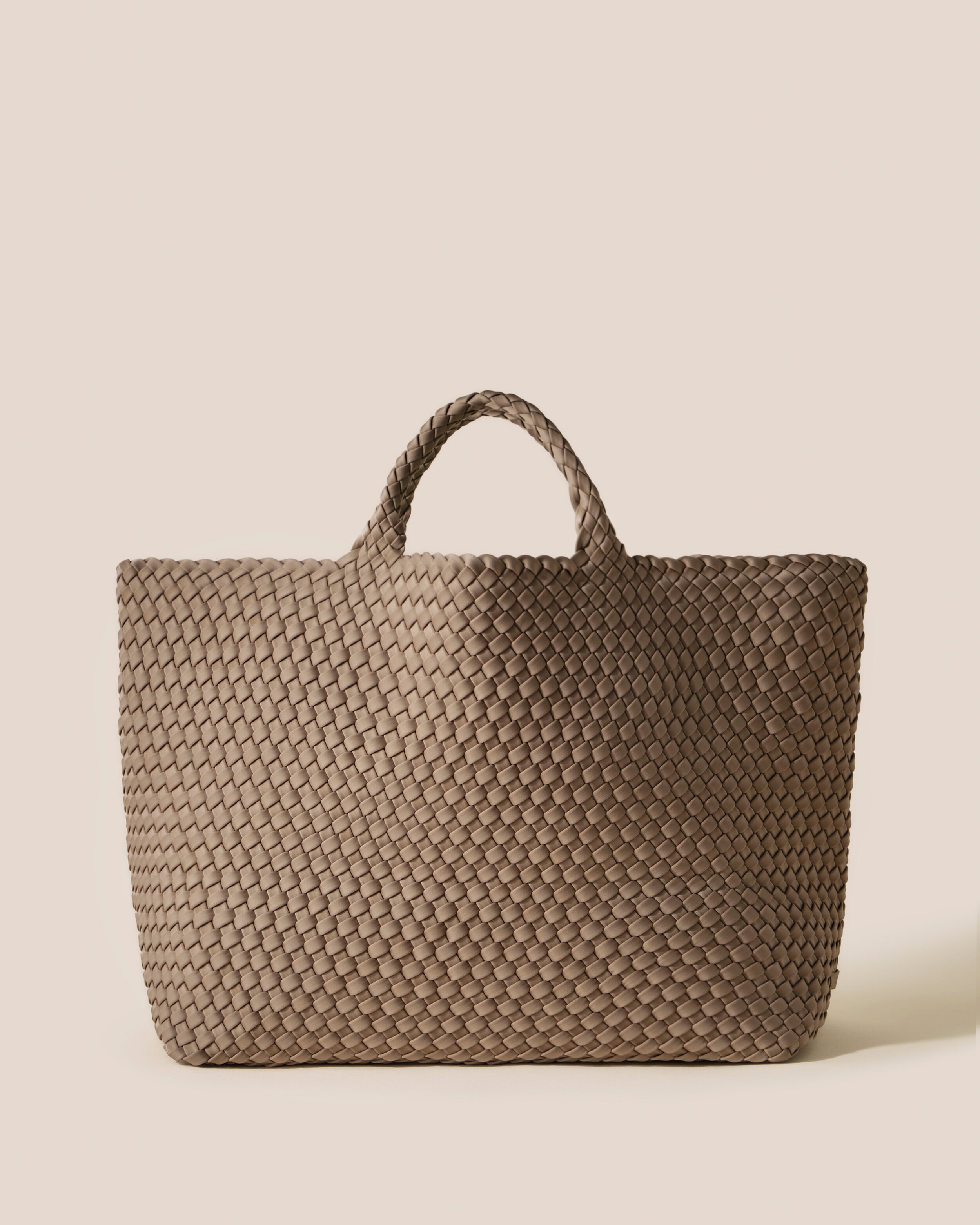 St. Barths Tote in Cashmere, a taupe tone, in handwoven neoprene, featuring an open top, and woven top handles.