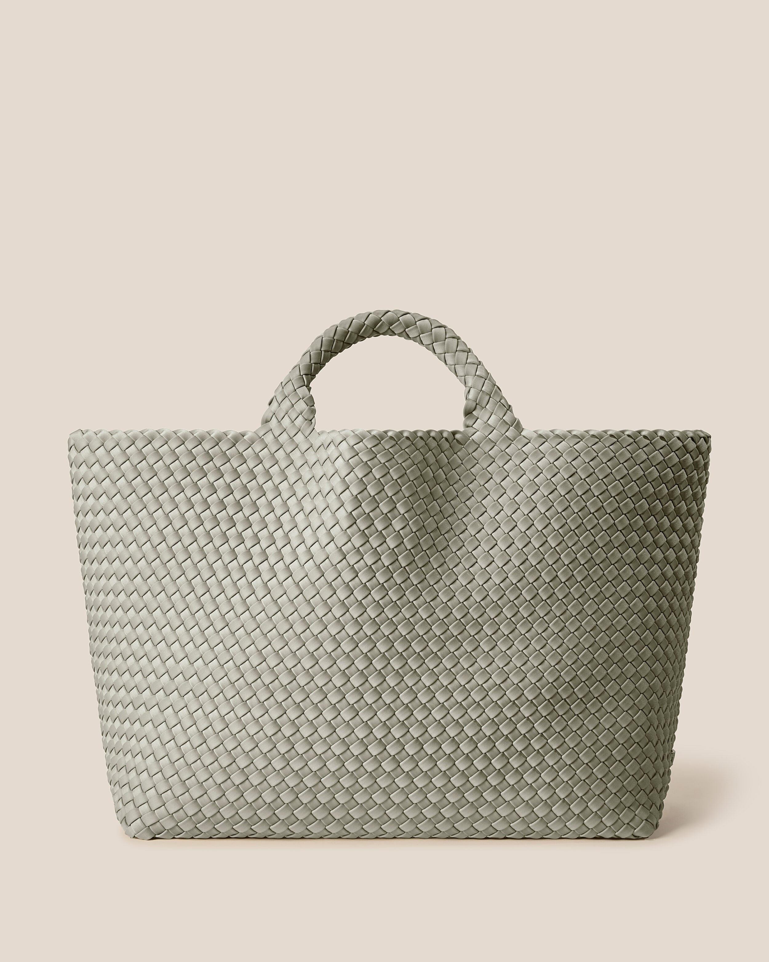 St. Barths Tote in Celadon, a light jade green tone, in handwoven neoprene, featuring an open top, and woven top handles.