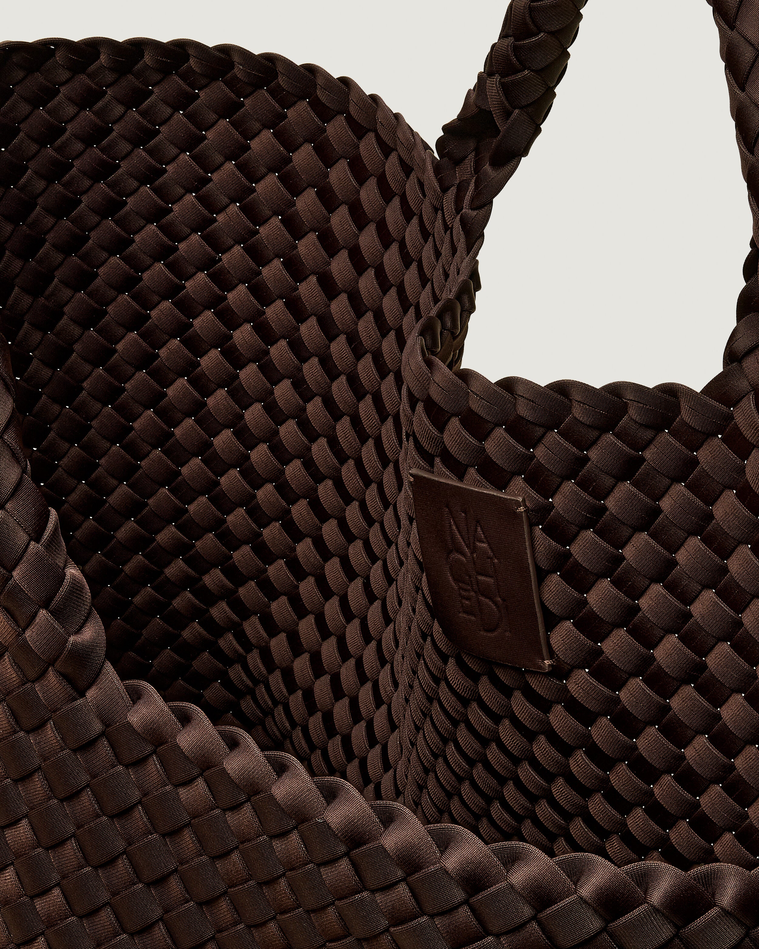 Interior close-up of St. Barths Tote in Chocolate showing its open top, and unlined interior.