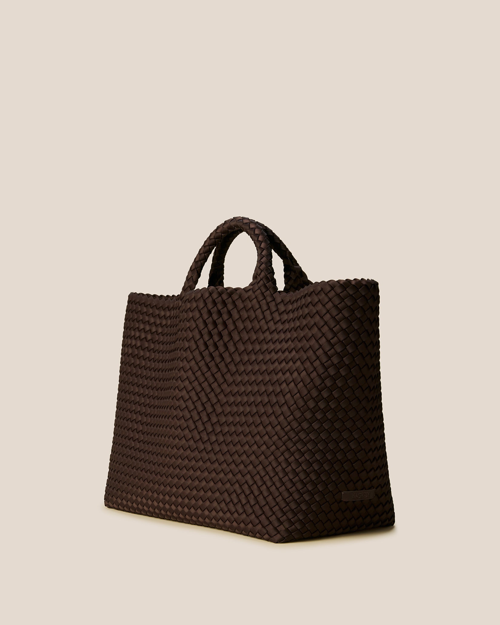 St. Barths Large Tote Bag in Chocolate shown from a side angle, highlighting its handwoven neoprene and open top.
