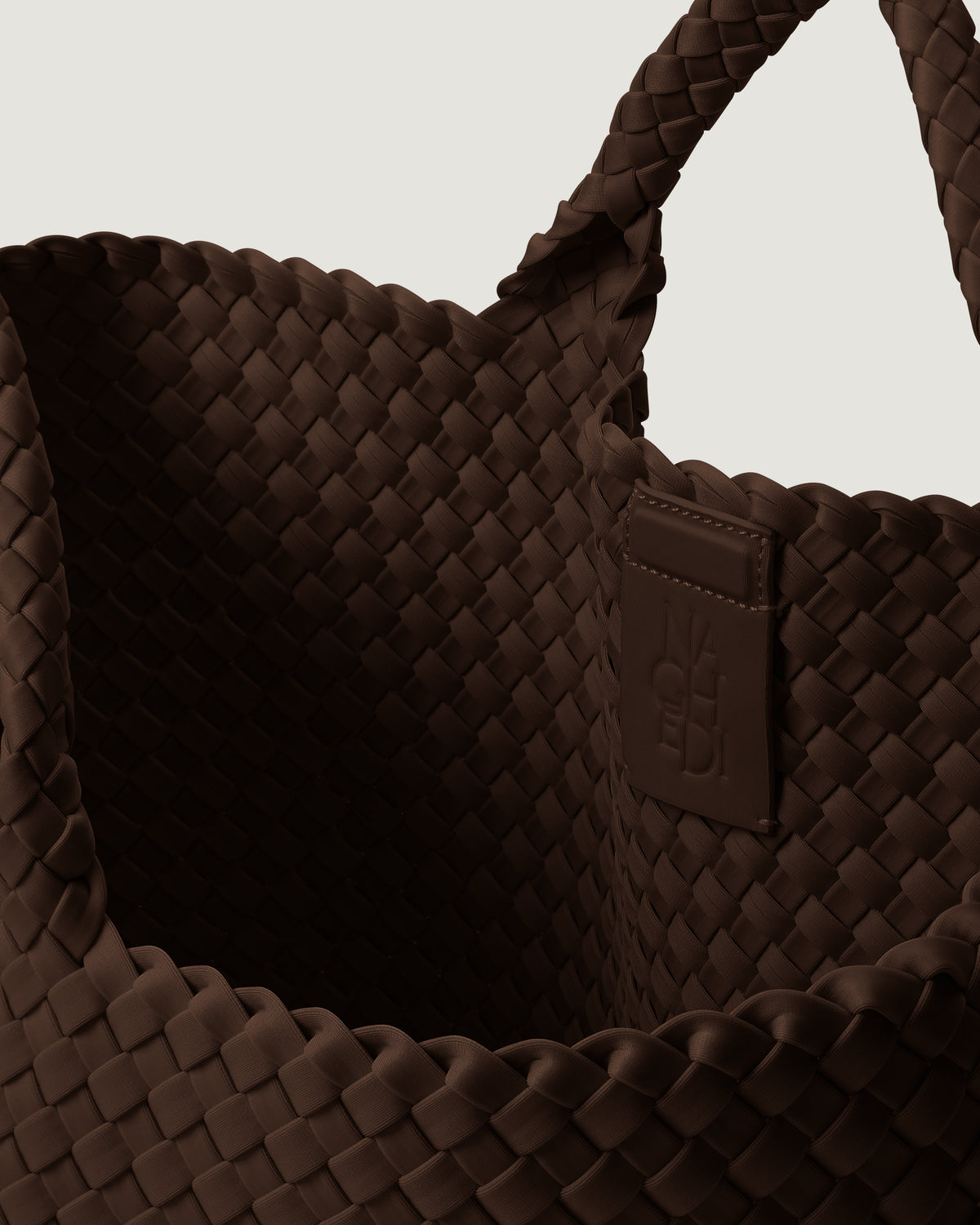 Interior close-up of St. Barths Tote in Chocolate showing its magnetic snap closure, and unlined interior.