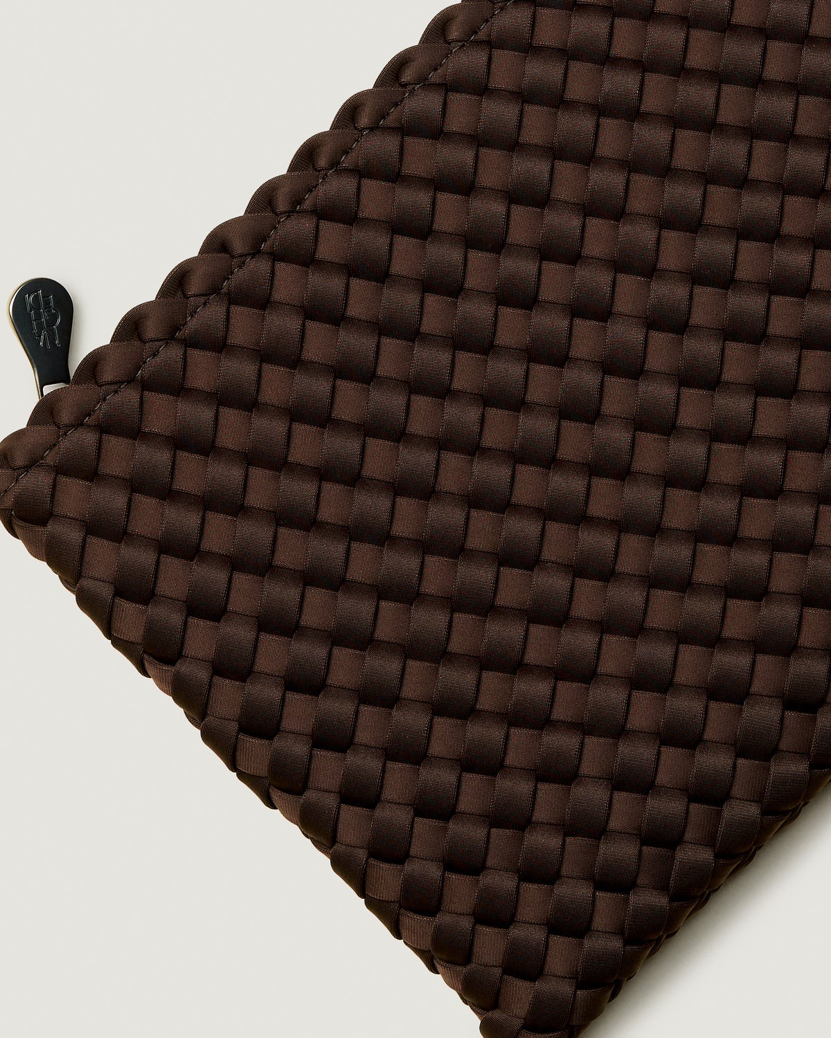 Close-up of included matching woven zippered pouch.