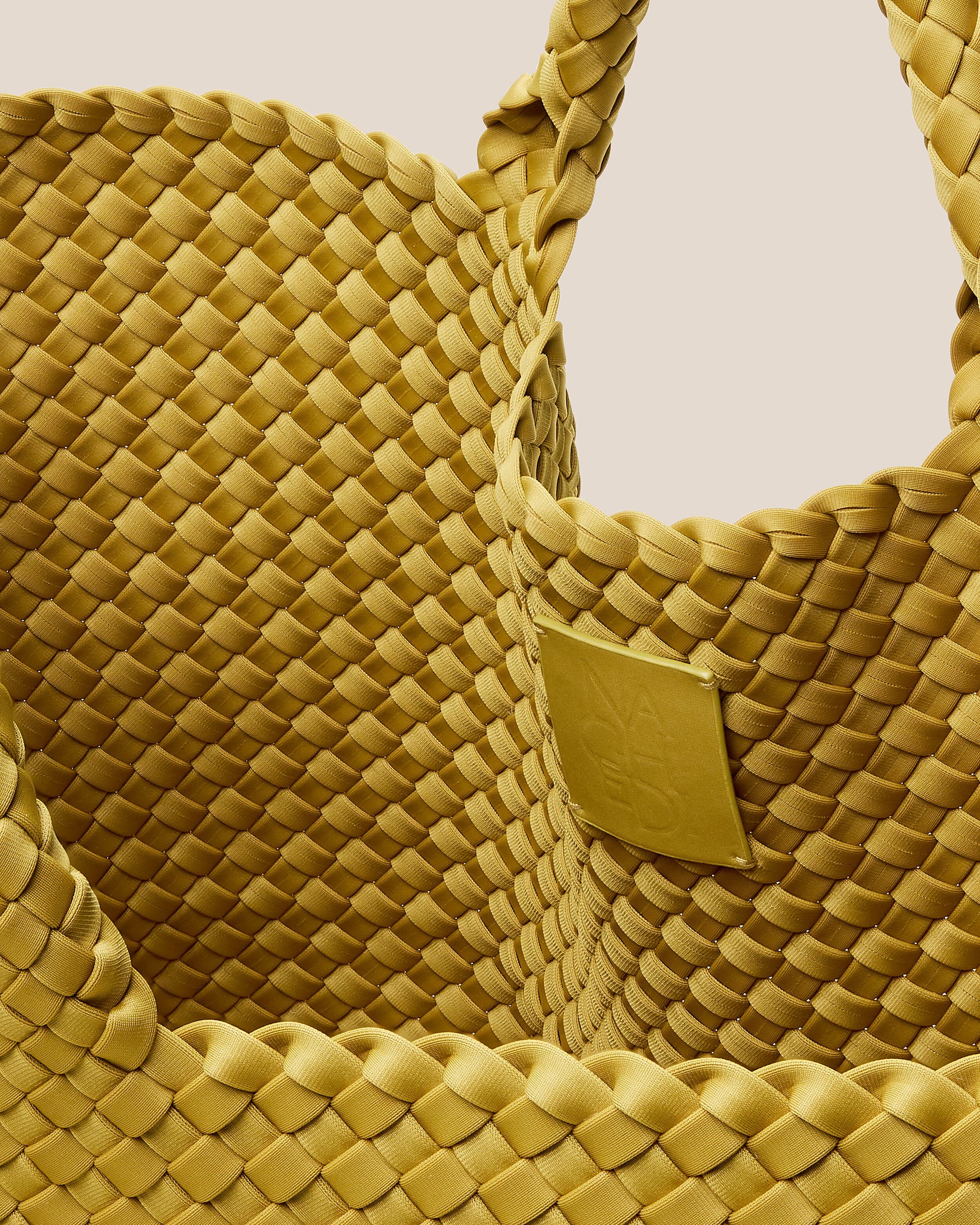 Interior close-up of St. Barths Tote in Citrine showing its open top, and unlined interior.