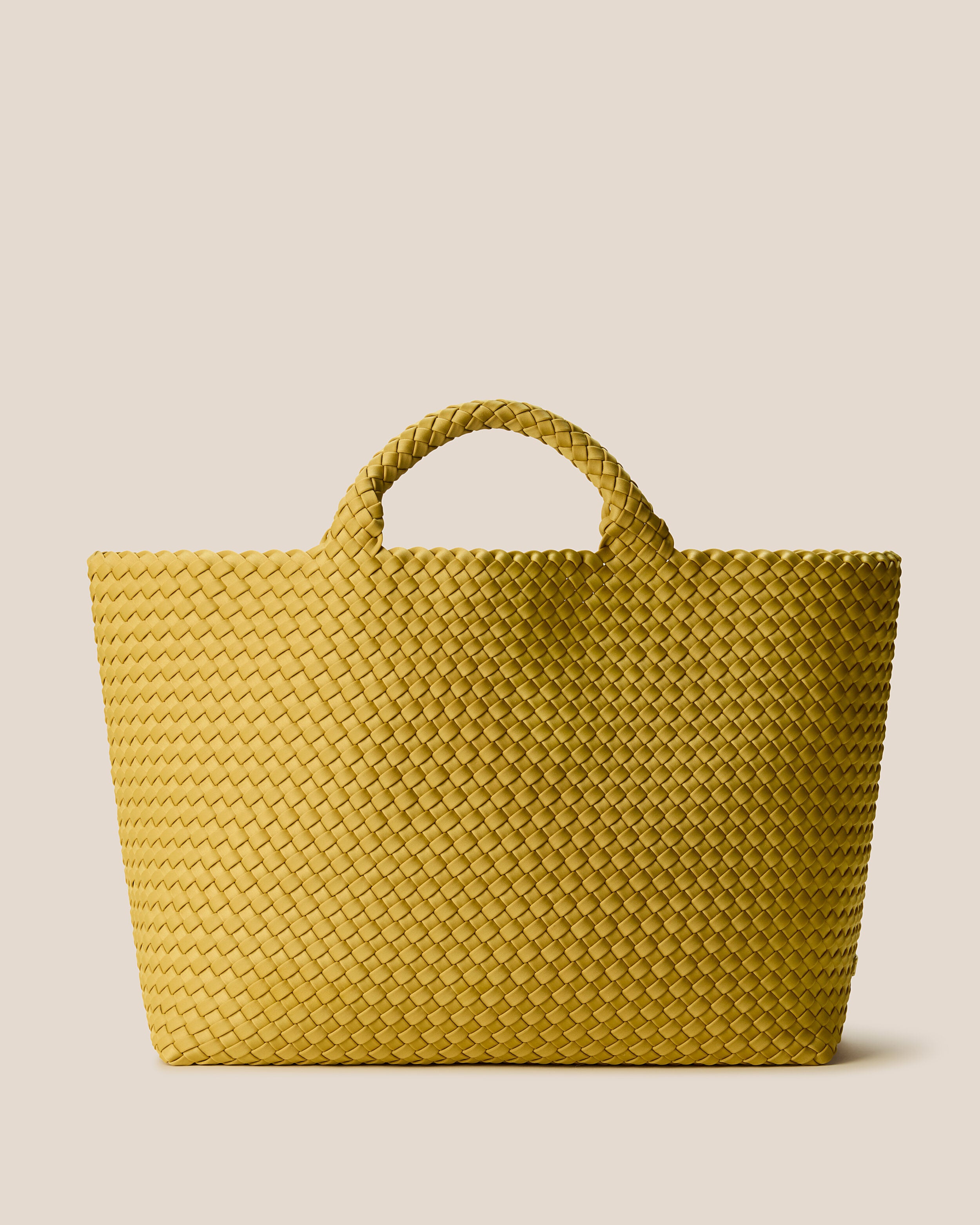 St. Barths Tote in Citrine, a mustard gold tone, in handwoven neoprene, featuring an open top, and woven top handles.