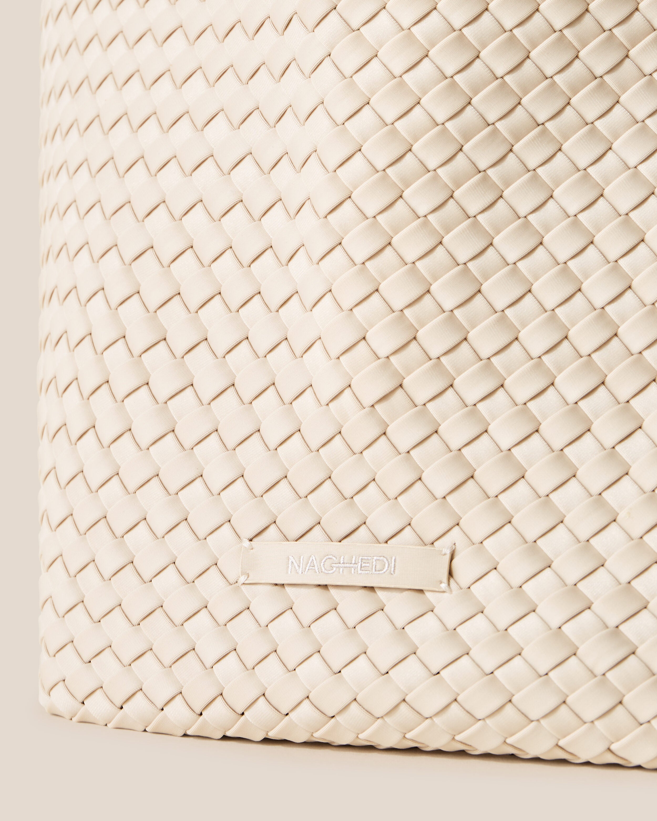 Close-up of stamped NAGHEDI logo on St. Barths Tote in Ecru.