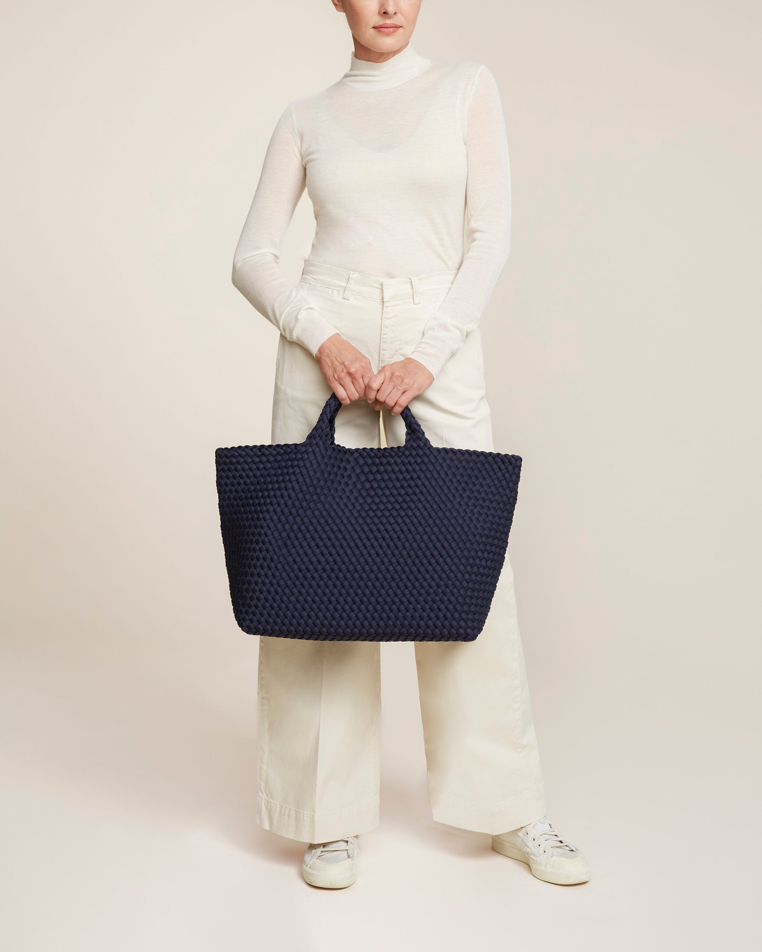 St. Barths Tote in Ink Blue shown on model to illustrate scale and soft silhouette.