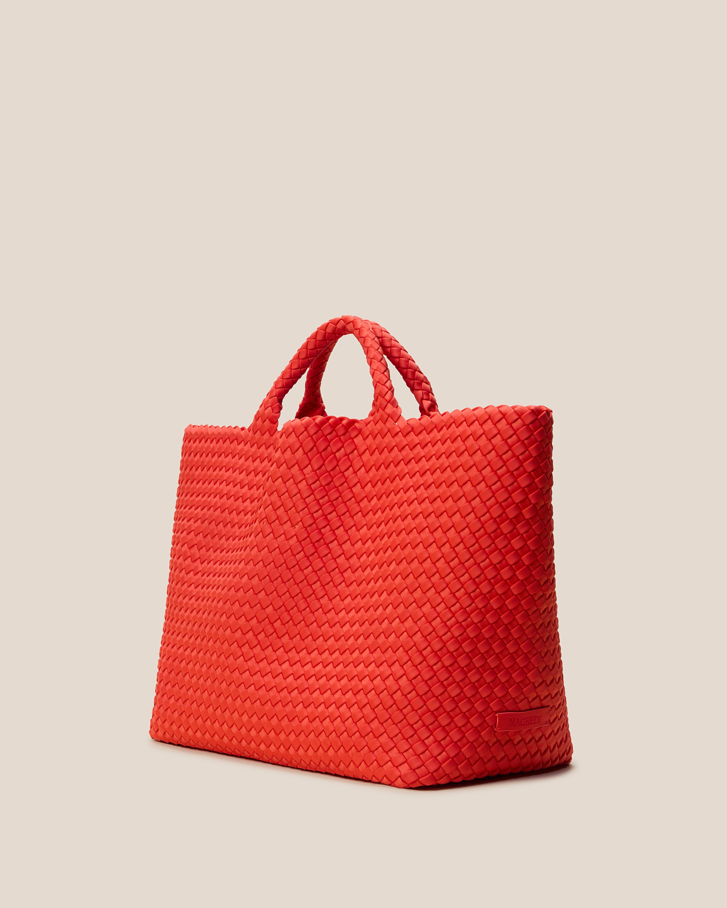 St. Barths Tote in Ipanema shown from a side angle, highlighting its handwoven neoprene construction and open top.