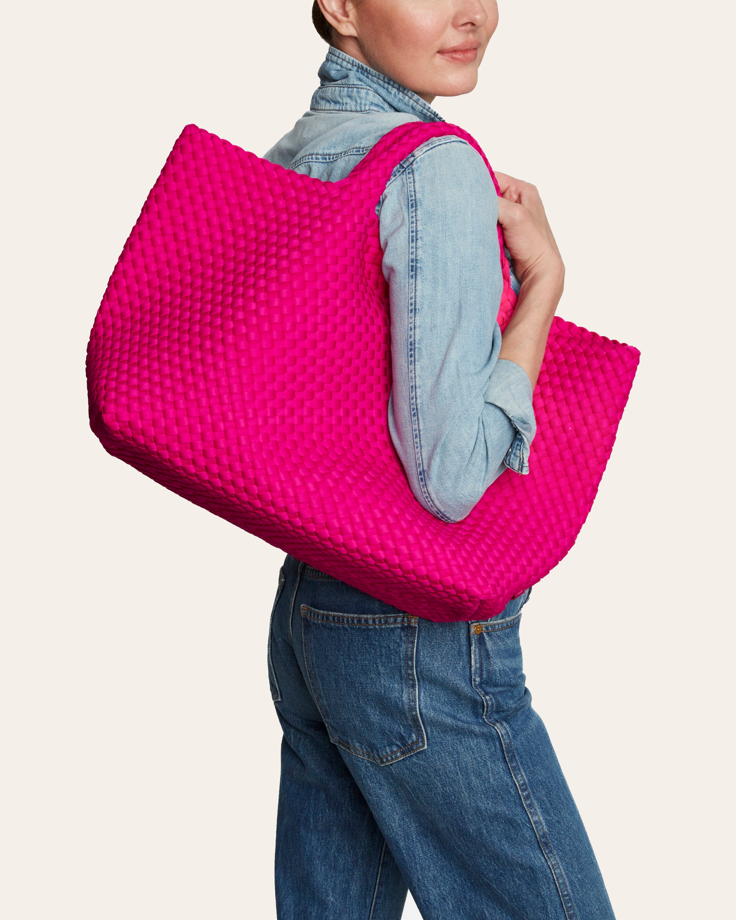 St. Barths Tote in Miami Pink shown on model to illustrate scale and soft silhouette.
