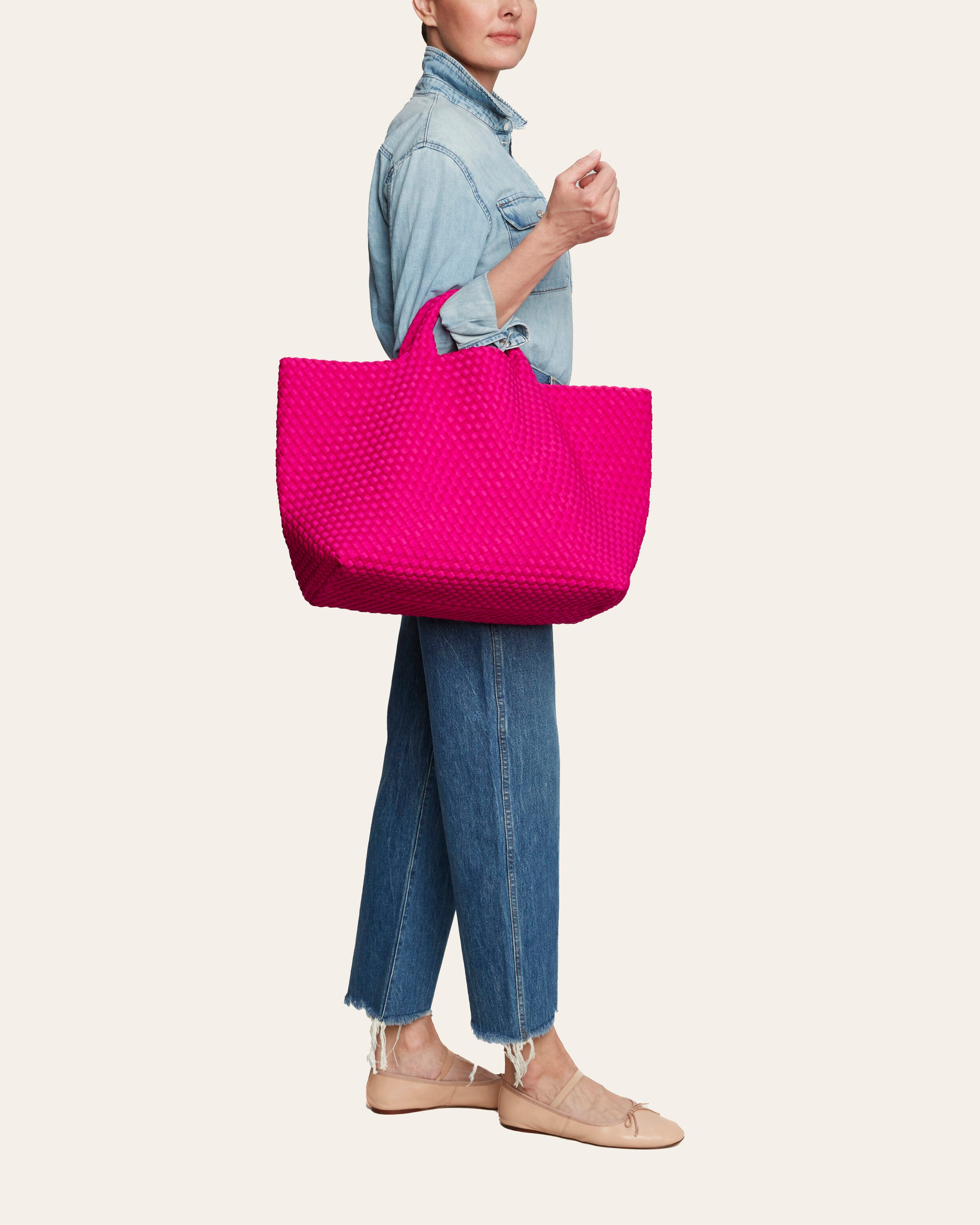 St. Barths Tote in Miami Pink shown on model to illustrate scale and soft silhouette.