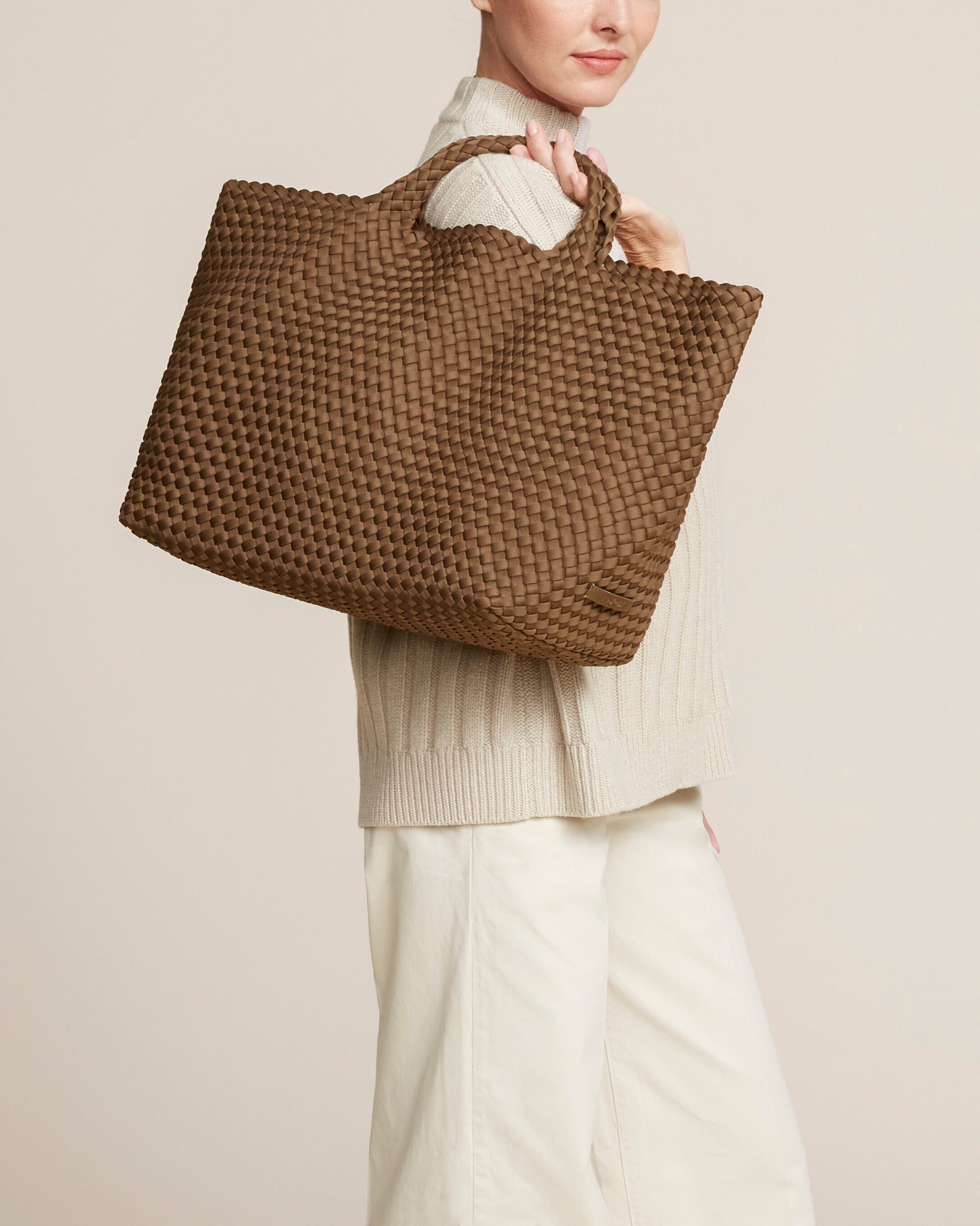 St. Barths Tote in Mink shown on model to illustrate scale and soft silhouette.