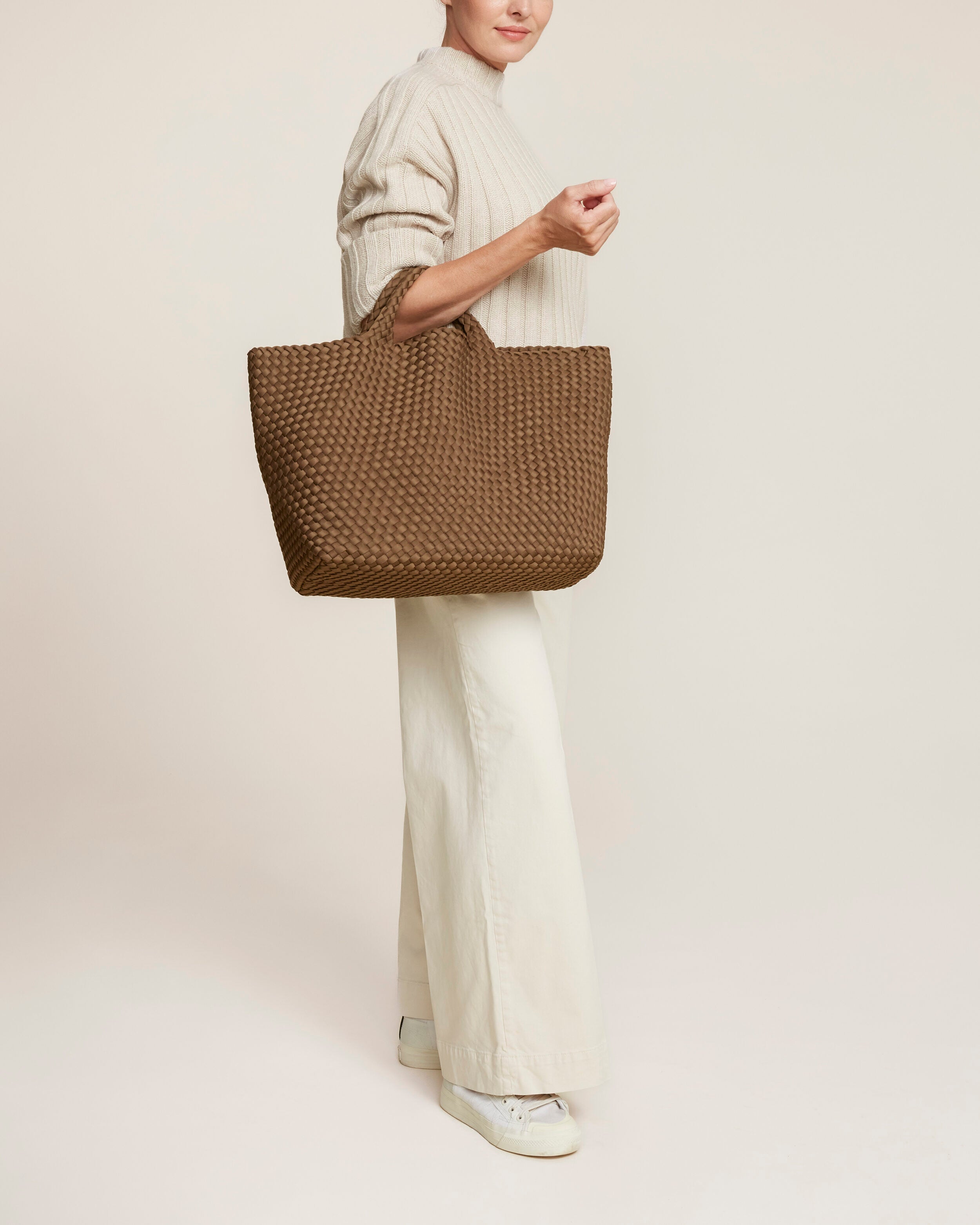 St. Barths Tote in Mink shown on model to illustrate scale and soft silhouette.