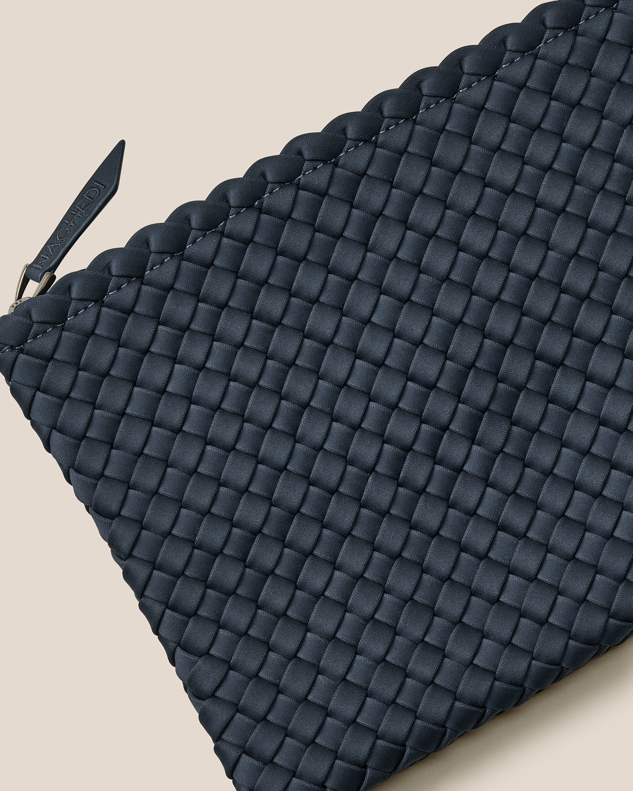 Close-up of included matching woven zippered pouch.