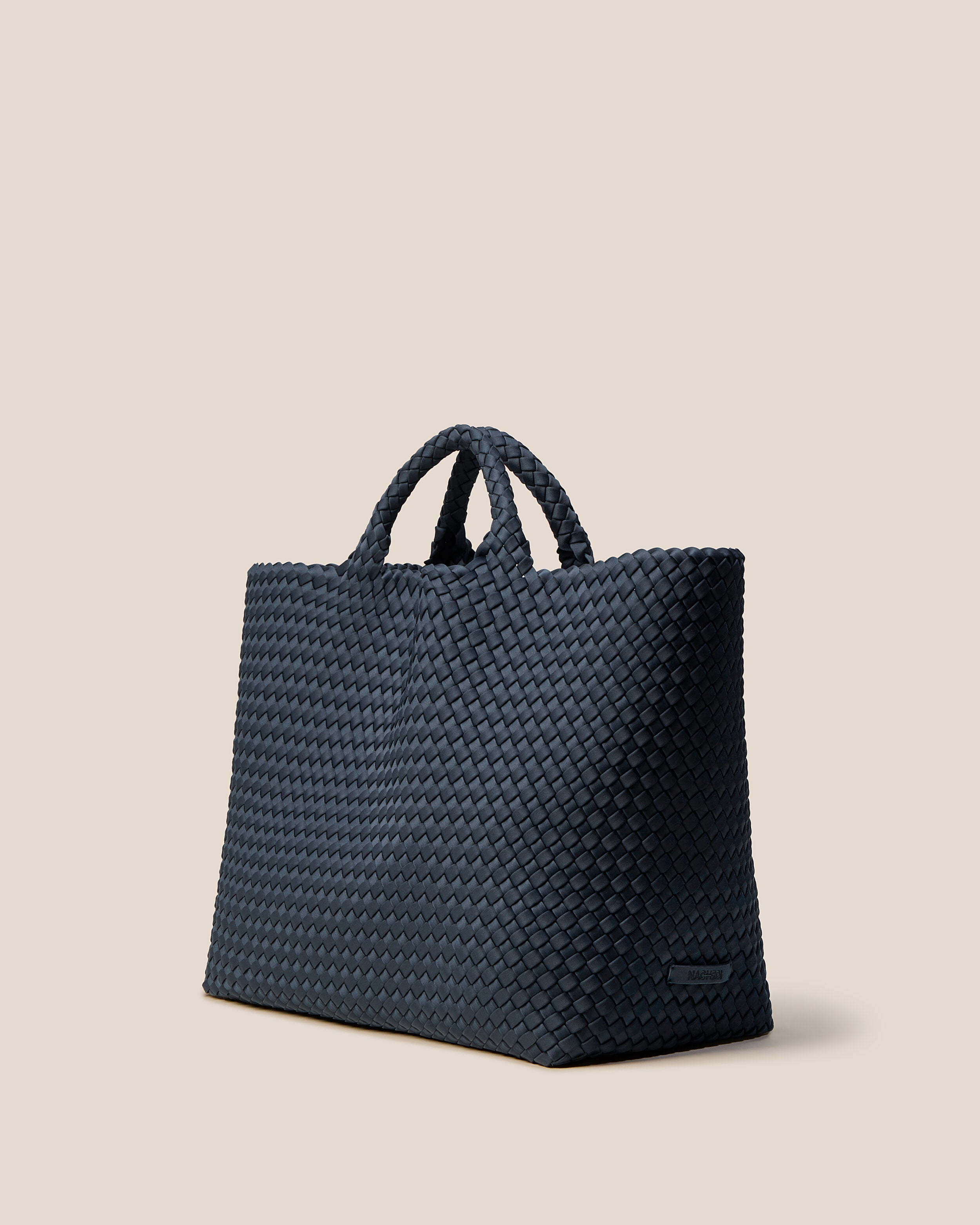 St. Barths Tote in Murano shown from a side angle, highlighting its handwoven neoprene construction and open top.
