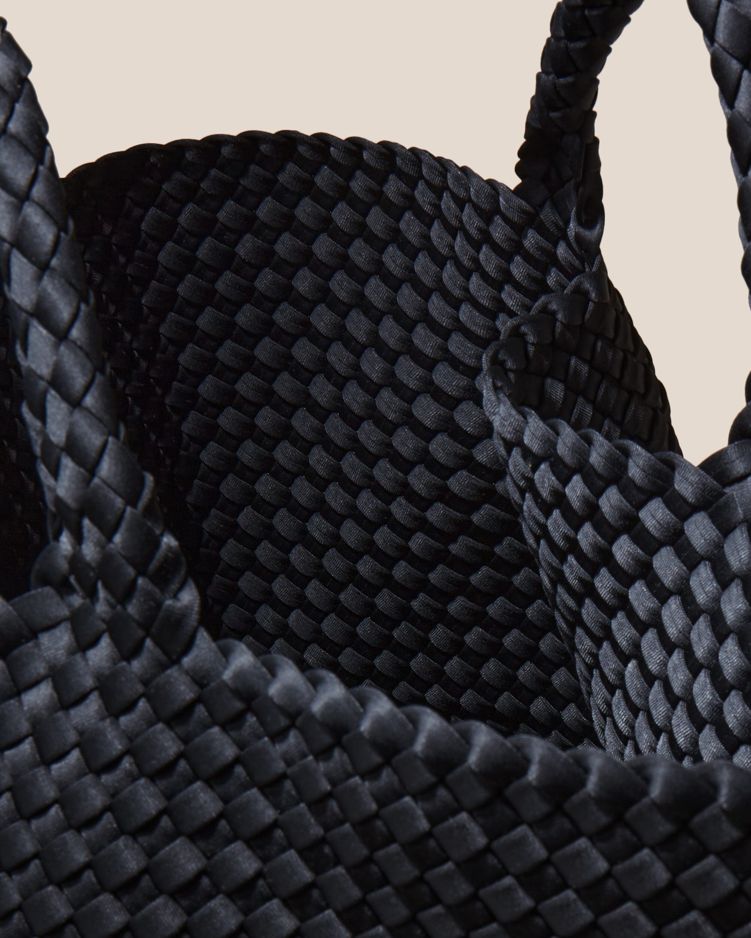 Interior close-up of St. Barths Tote in Onyx showing its open top, and unlined interior.