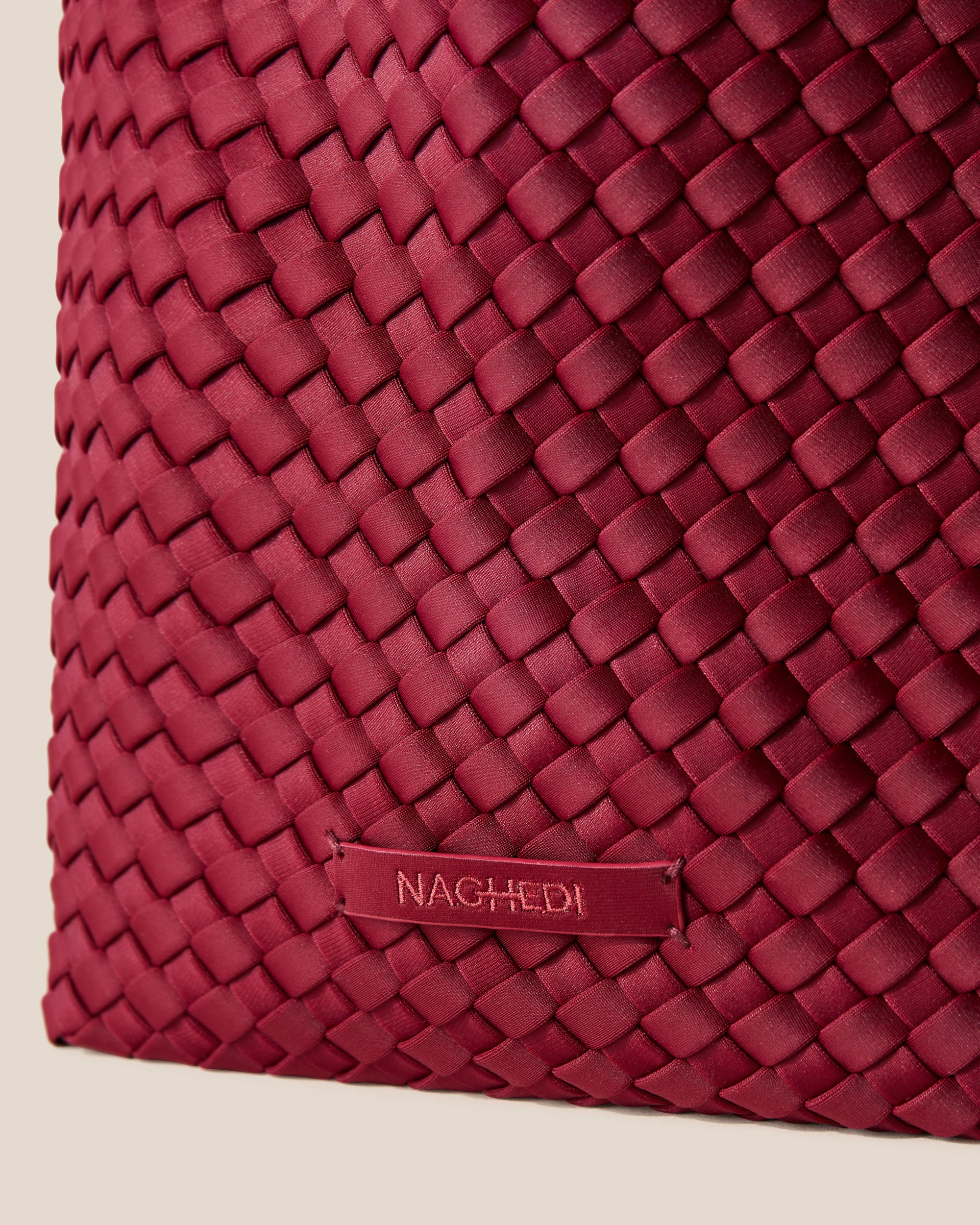 Close-up of stamped NAGHEDI logo on St. Barths Tote in Rosewood.