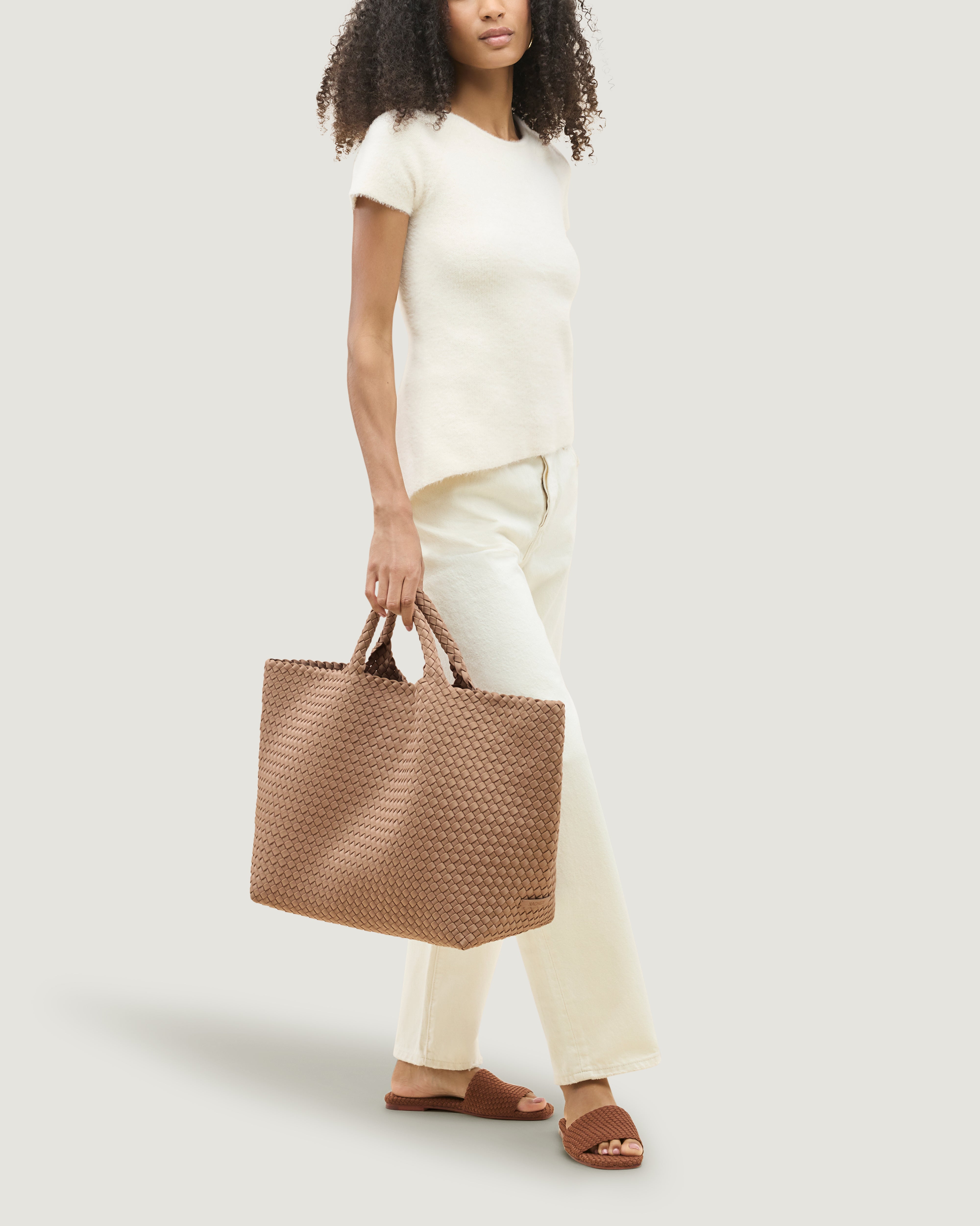 St. Barths Tote in Seychelles shown on model to illustrate scale and soft silhouette.