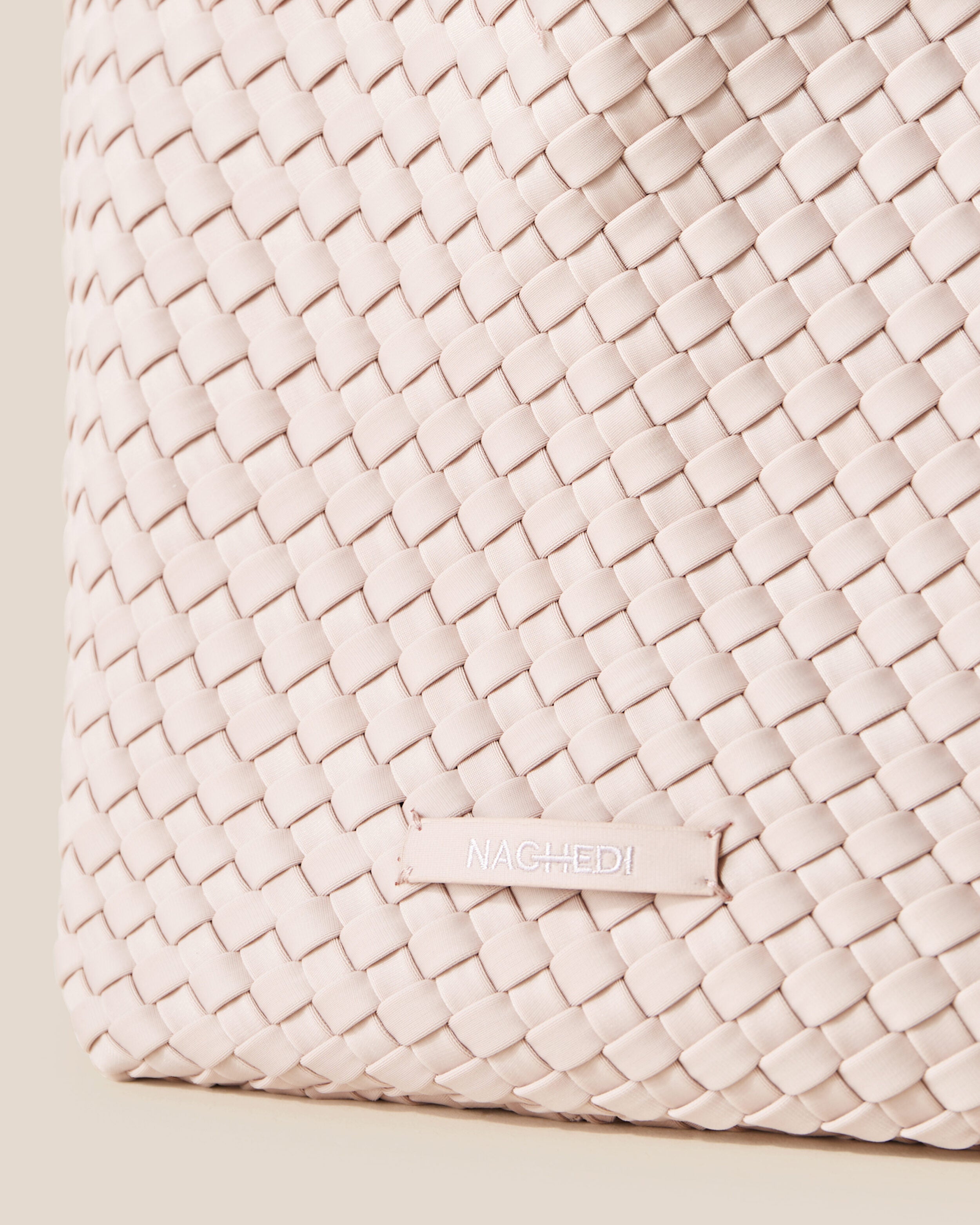 Close-up of stamped NAGHEDI logo on St. Barths Tote in Shell Pink.