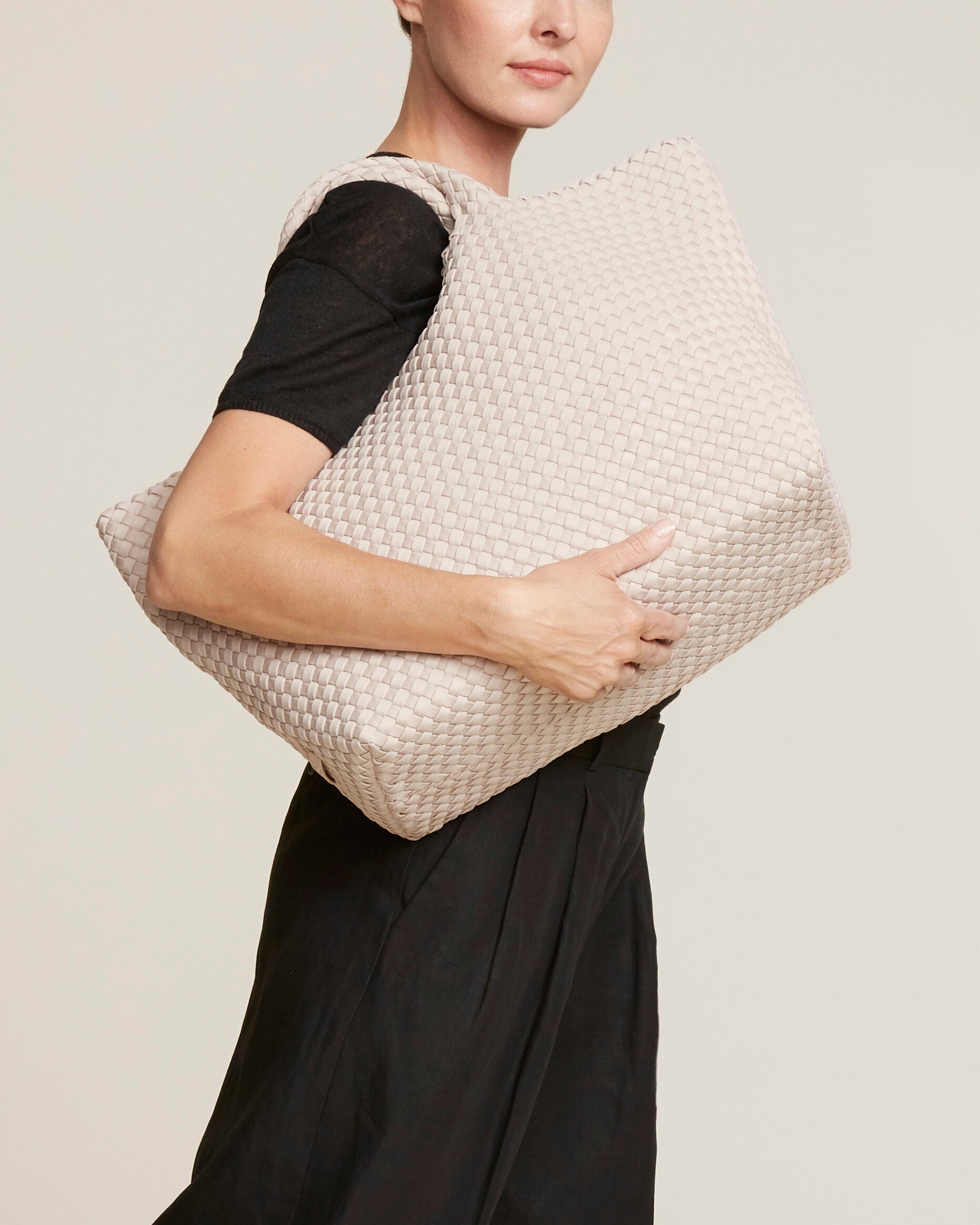 St. Barths Tote in Shell Pink shown on model to illustrate scale and soft silhouette.