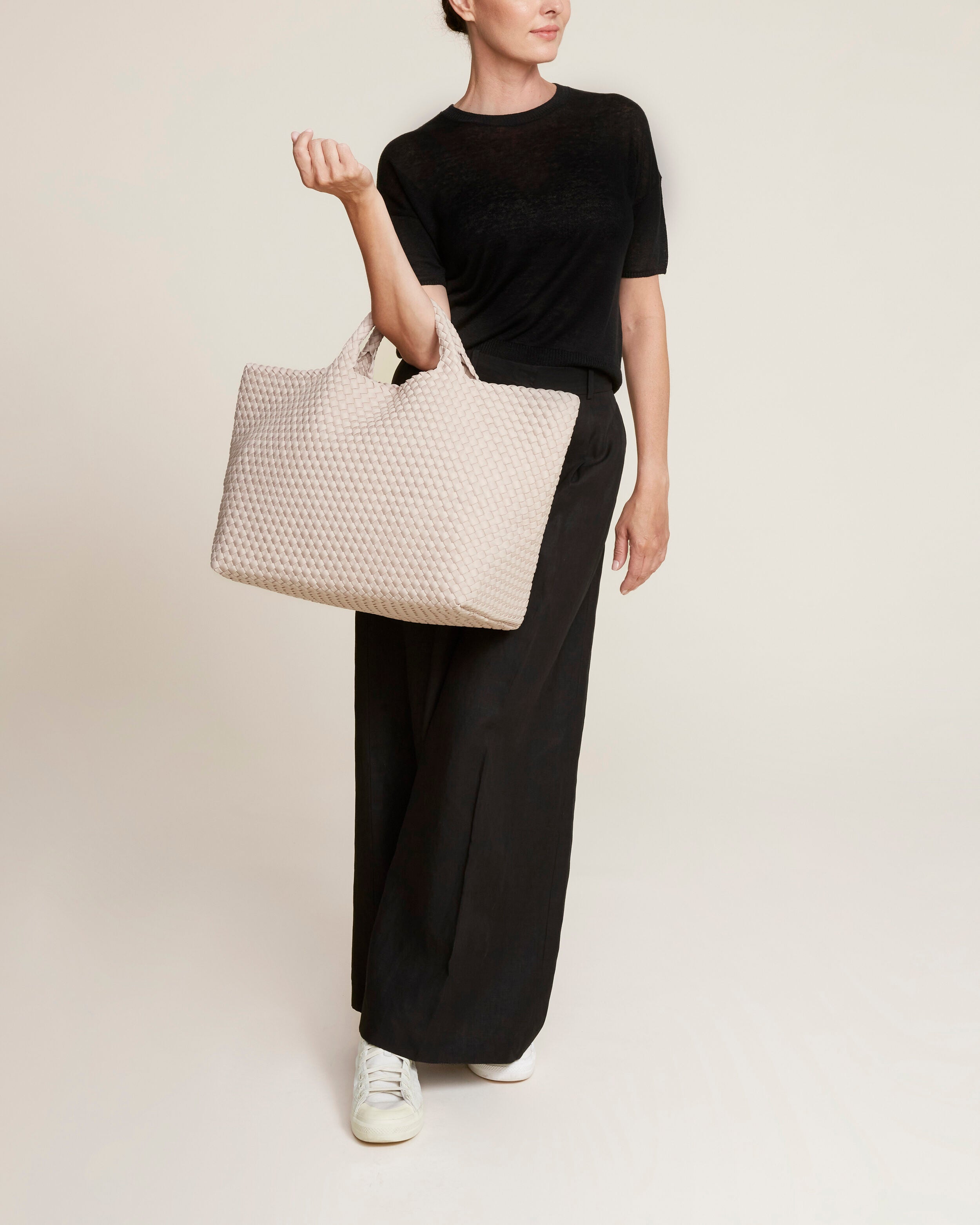 St. Barths Tote in Shell Pink shown on model to illustrate scale and soft silhouette.