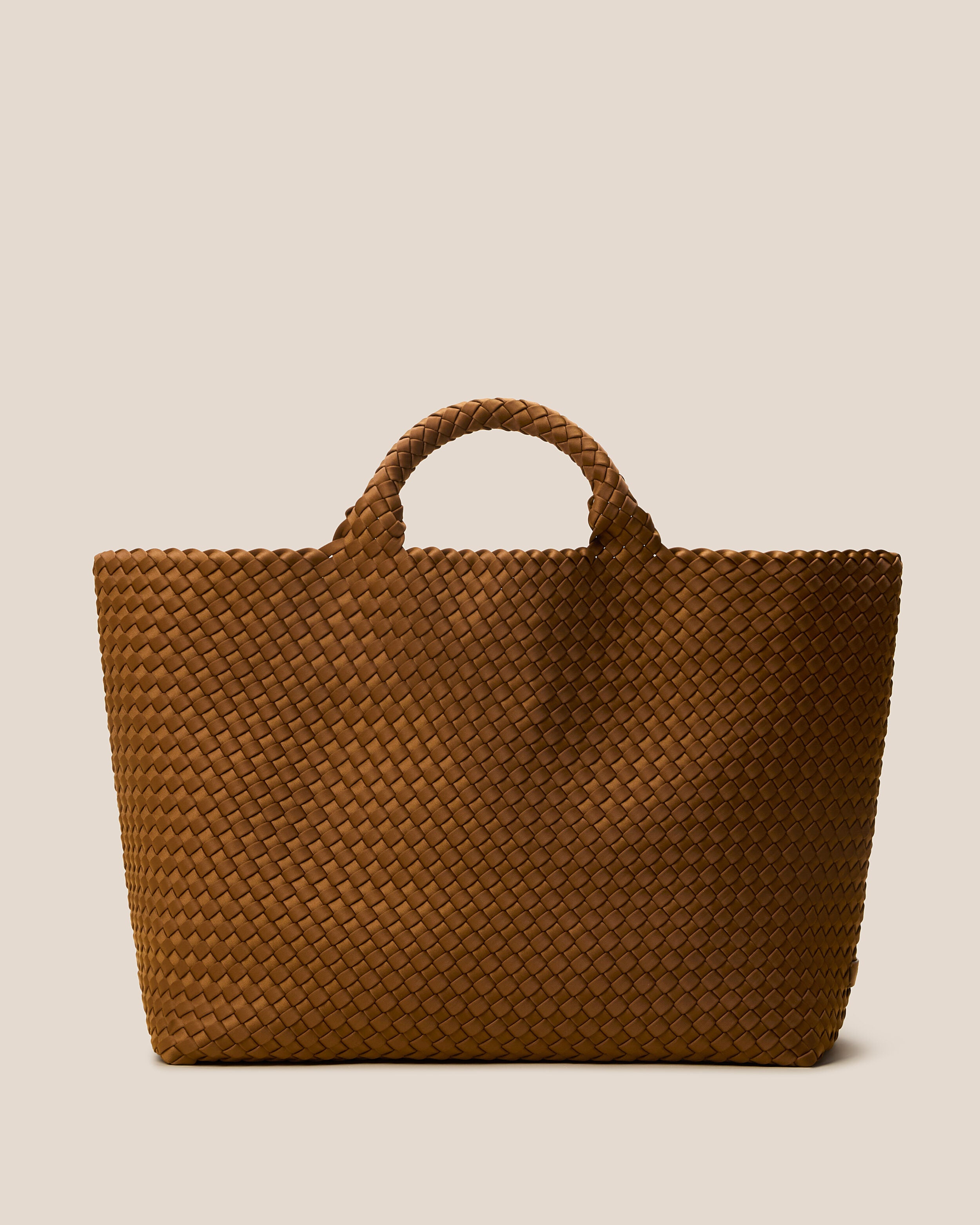 St. Barths Tote in Teak, a saddle brown tone, in handwoven neoprene, featuring an open top, and woven top handles.