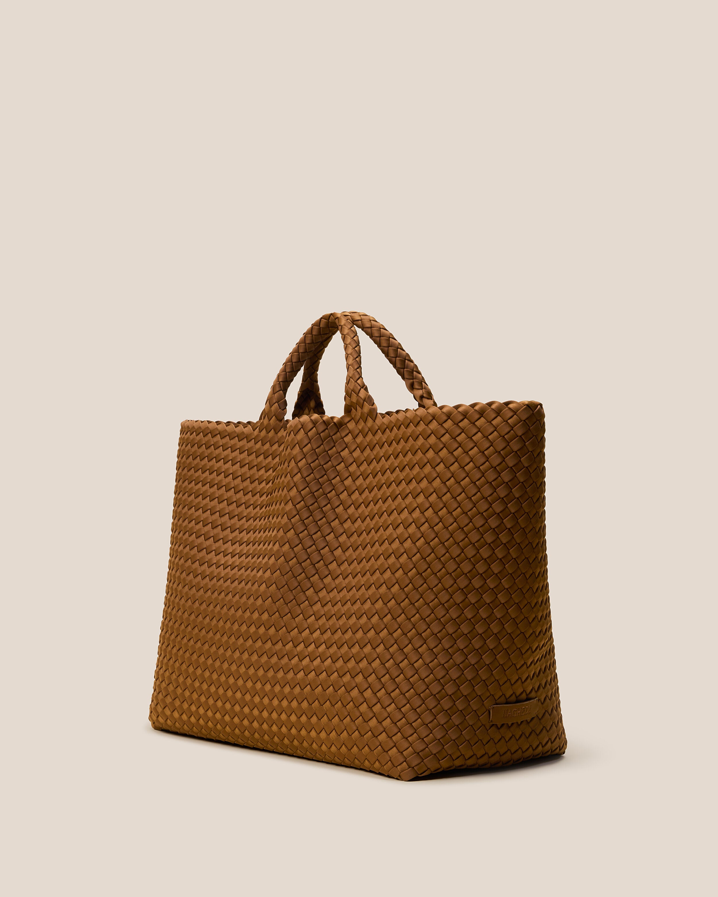 St. Barths Tote in Teak shown from a side angle, highlighting its handwoven neoprene construction and open top.