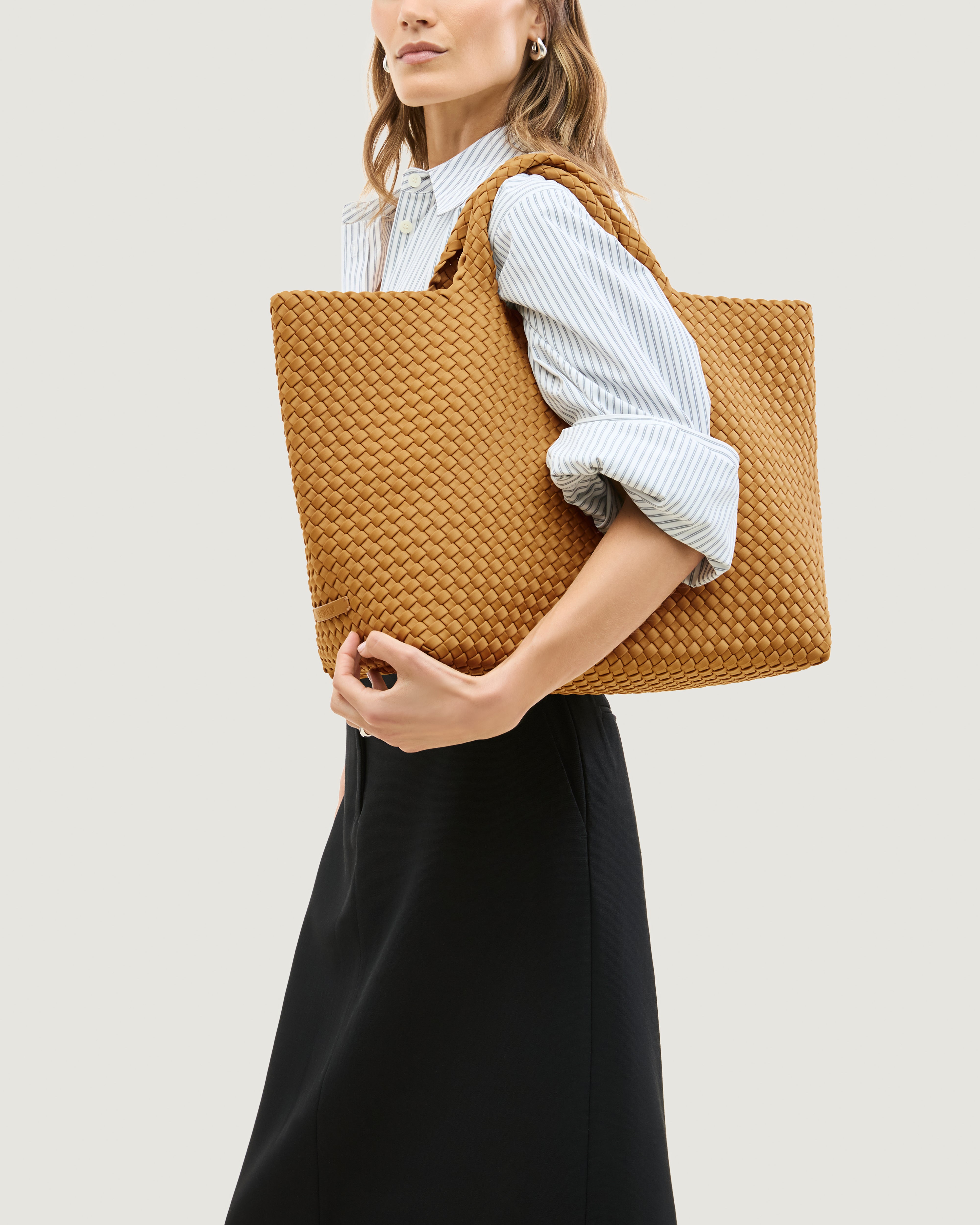 St. Barths Tote in Turmeric shown on model to illustrate scale and soft silhouette.