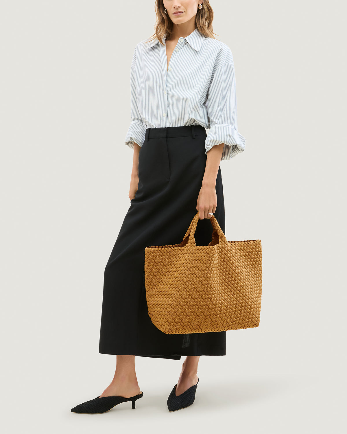 St. Barths Tote in Turmeric shown on model to illustrate scale and soft silhouette.