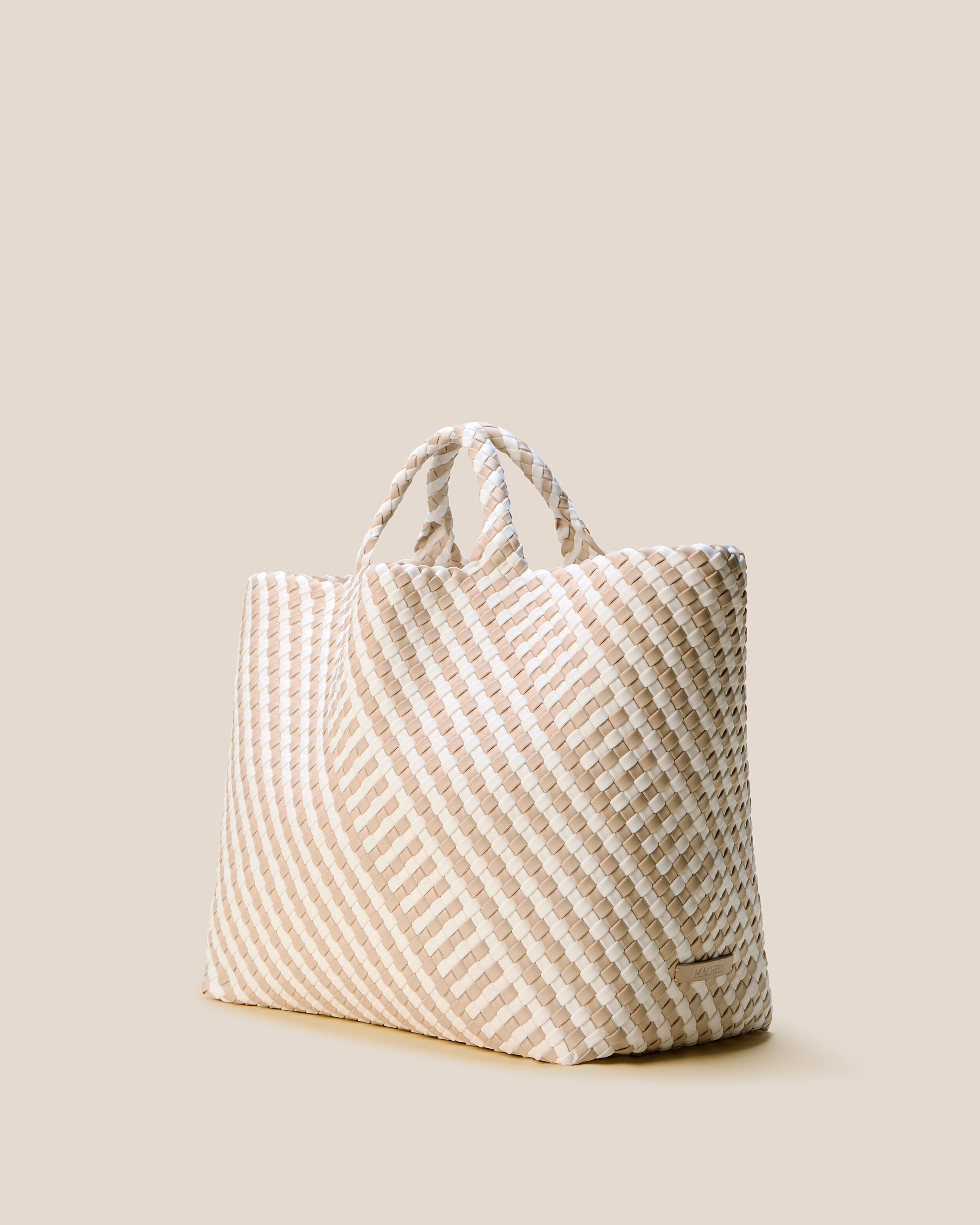 St. Barths Tote in Mykonos shown from a side angle, highlighting its handwoven neoprene construction and open top.