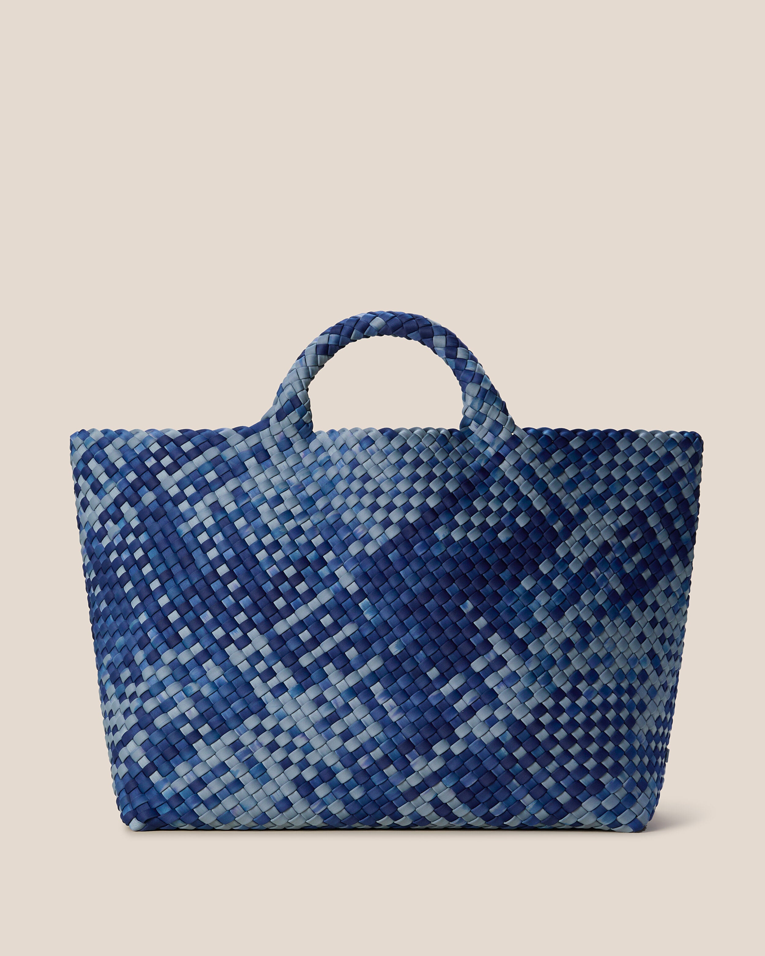 St. Barths Tote in Paros, a denim blue and navy tone, in handwoven neoprene, featuring an open top, and woven top handles.