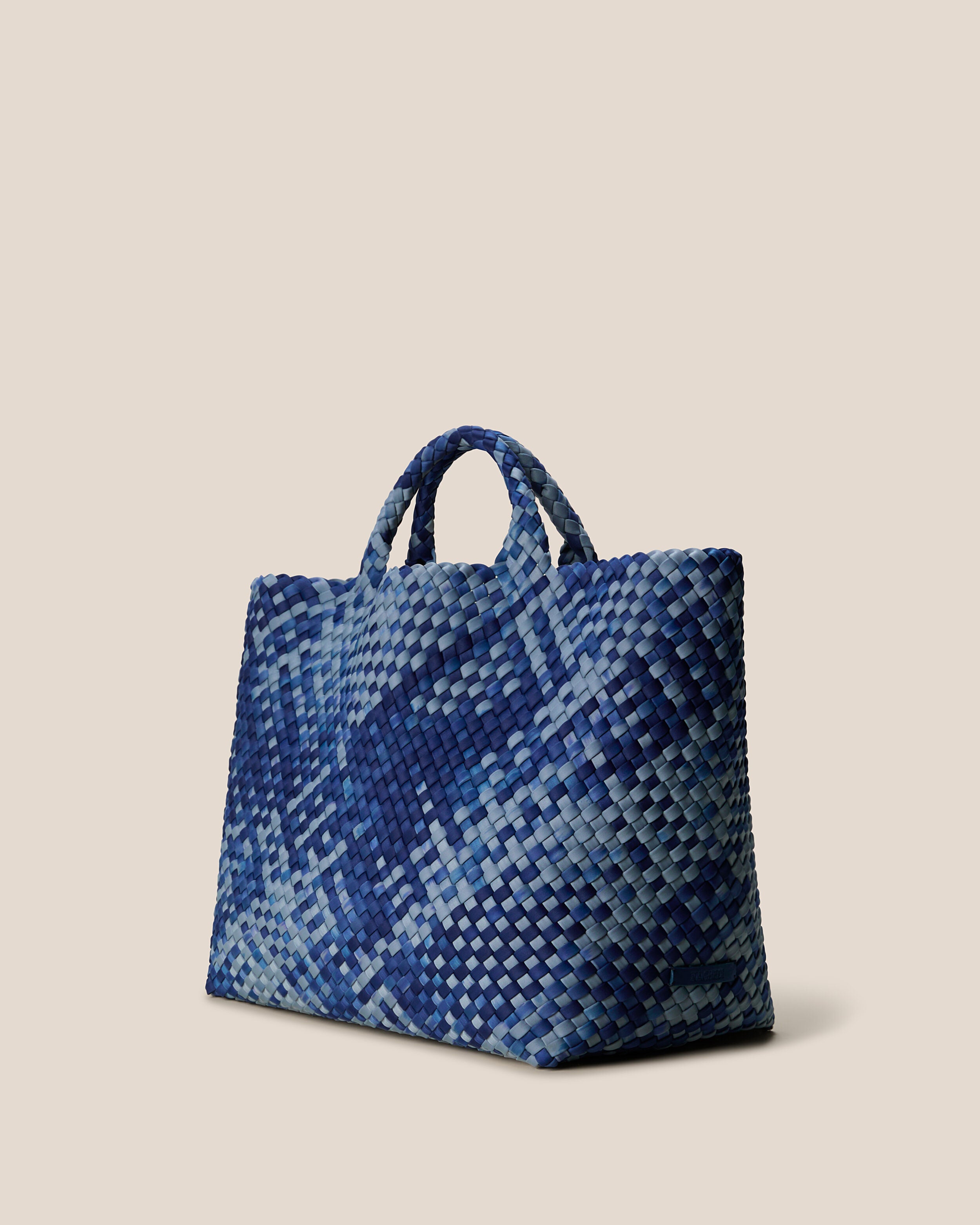 St. Barths Tote in Paros shown from a side angle, highlighting its handwoven neoprene construction and open top.