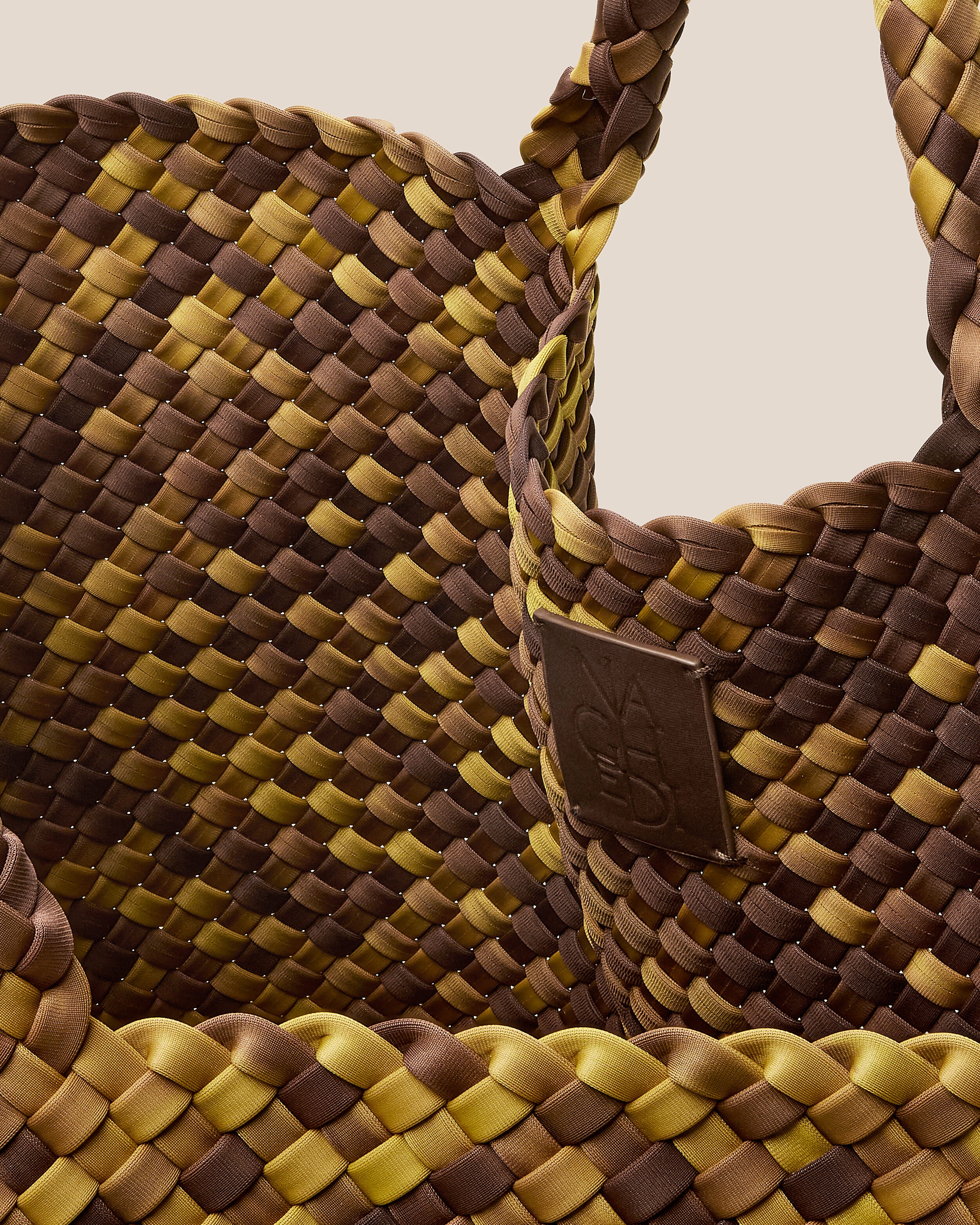 Interior close-up of St. Barths Tote in Tortoiseshell showing its open top, and unlined interior.