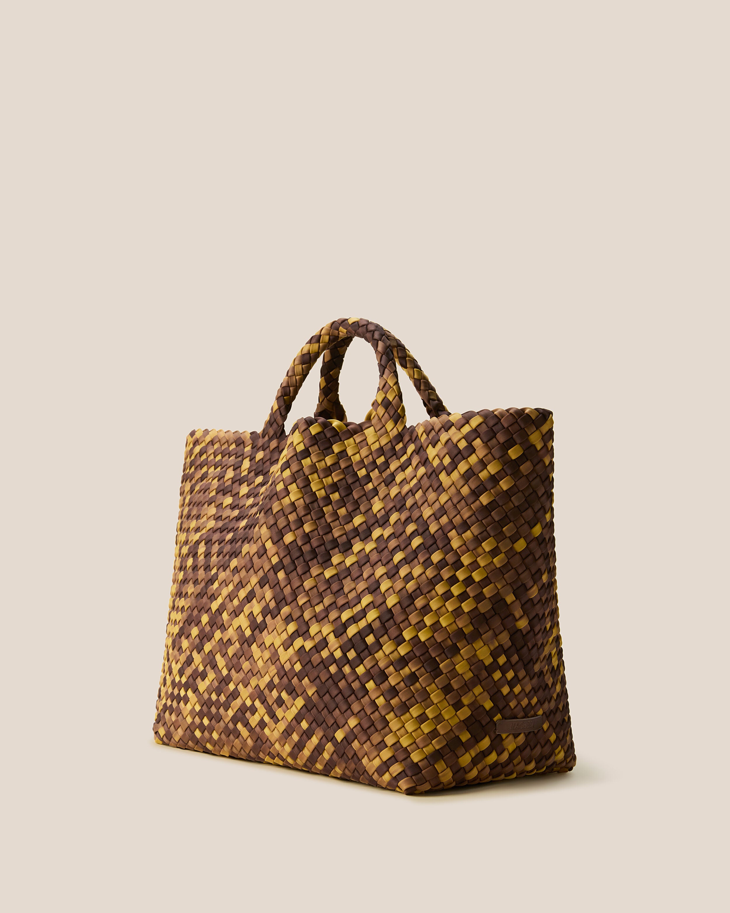 St. Barths Tote in Tortoiseshell shown from a side angle, highlighting its handwoven neoprene construction and open top.