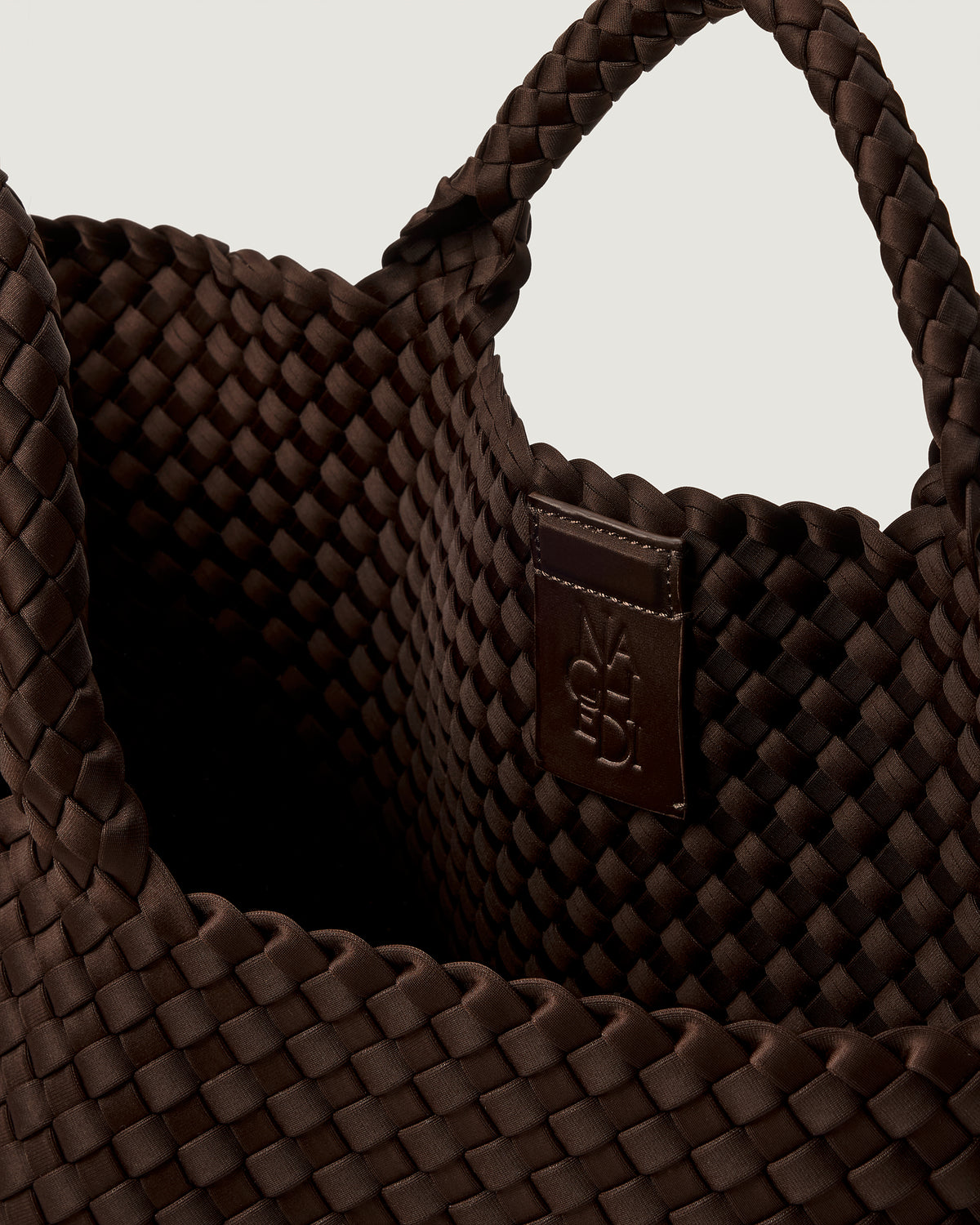 Interior close up on St Barths Medium Tote in Chocolate showing open top, unlined interior, and magnetic closure