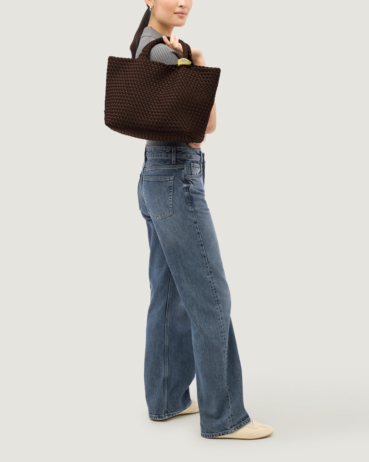 St. Barths Tote in Chocolate shown on model to illustrate scale and soft silhouette.