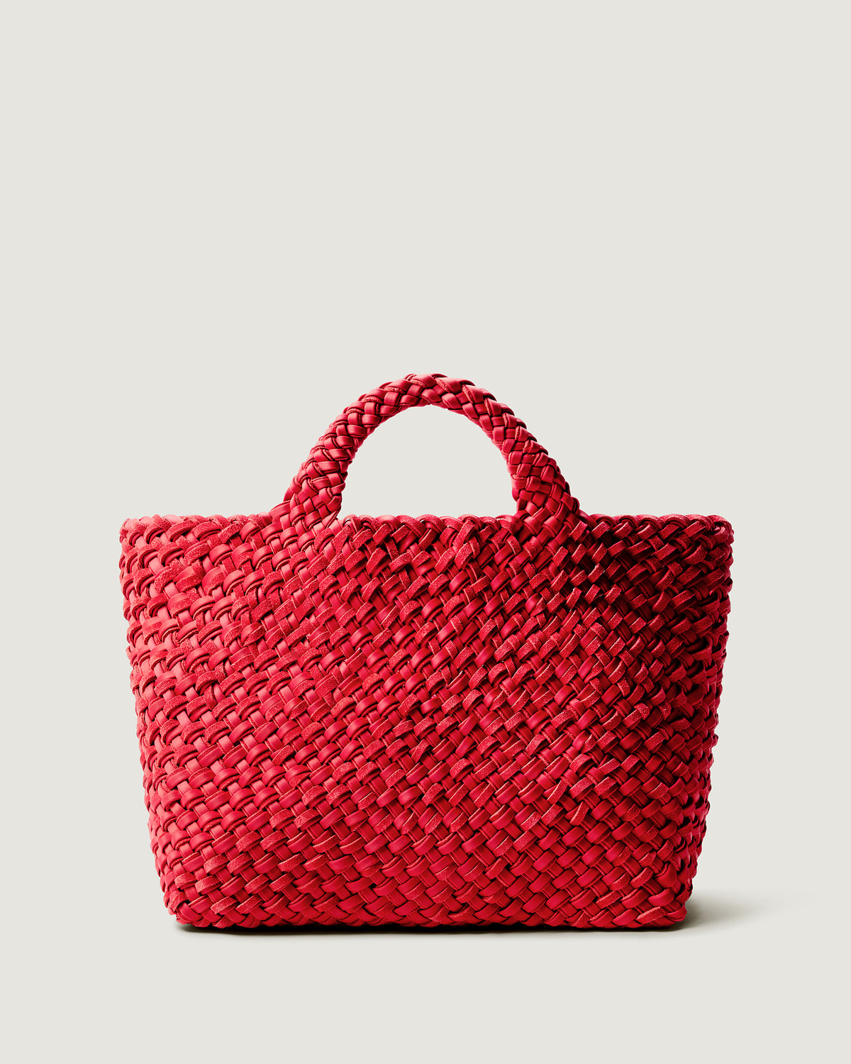 St. Barths Tote in Cerise, handwoven from doubled strands of bright cherry red neoprene and suede. Featuring an open top and woven handles.