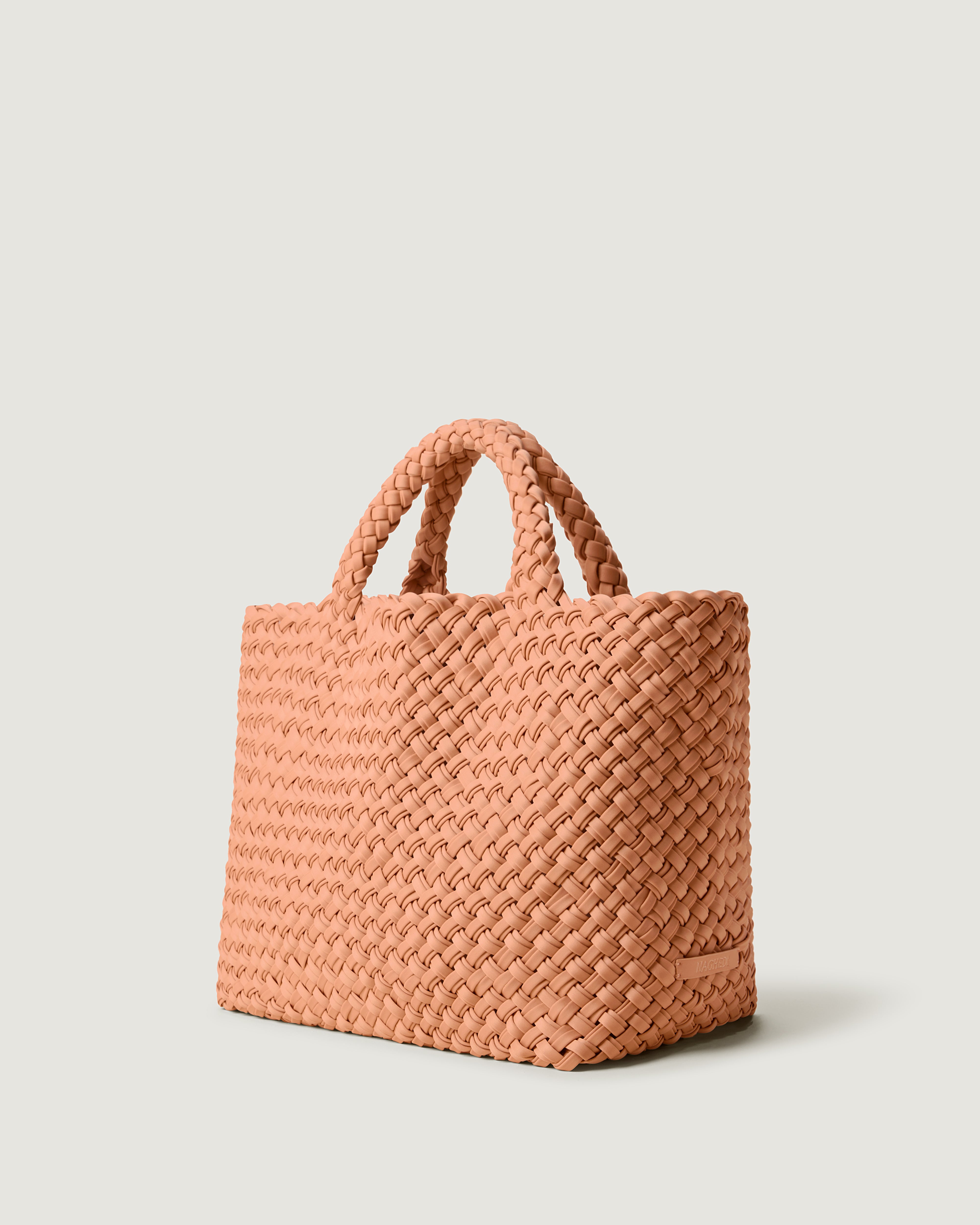 St. Barths Tote in Etna shown from a side angle, highlighting its handwoven neoprene construction and open top.