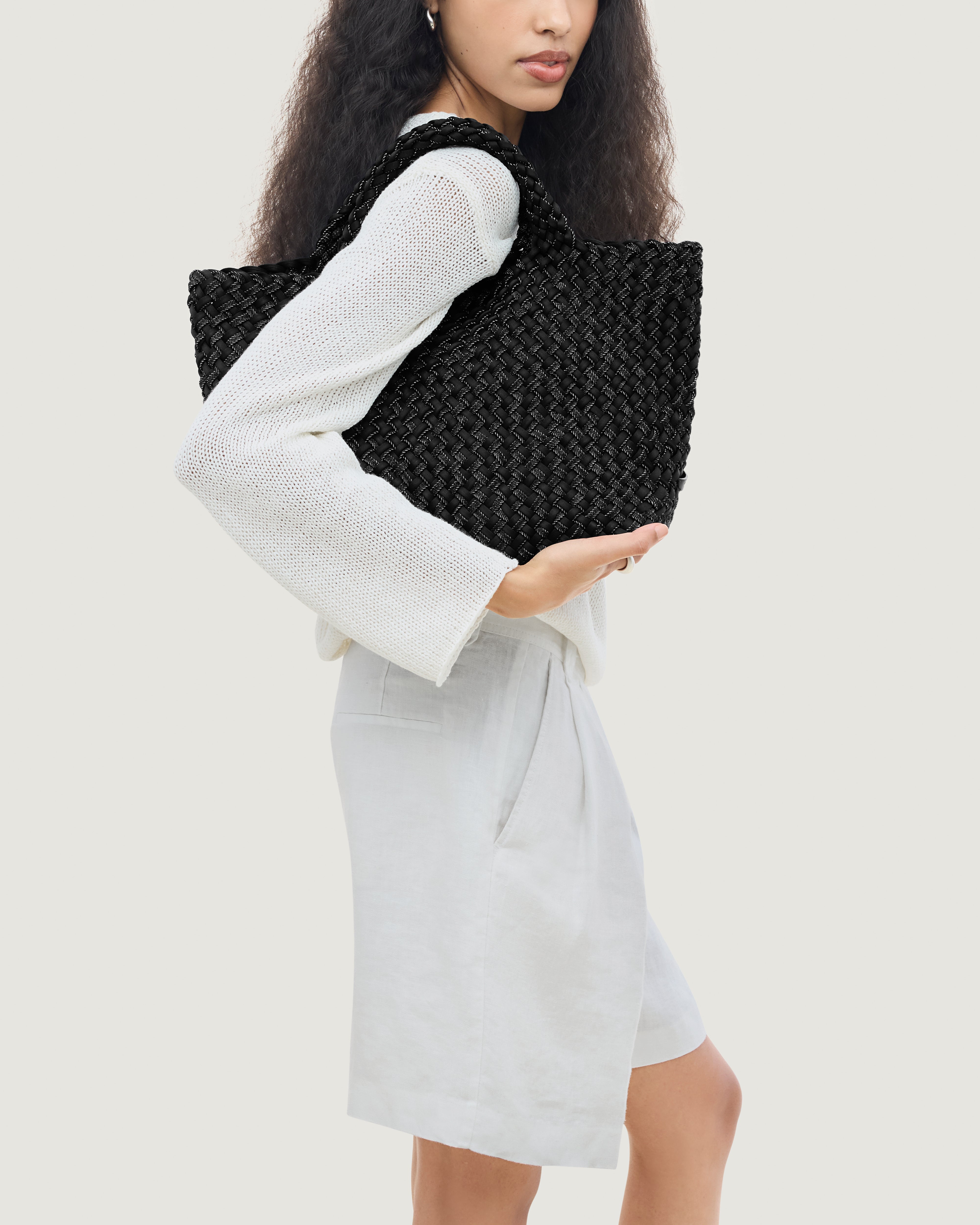 St. Barths Tote in Jet shown on model to illustrate scale and soft silhouette.
