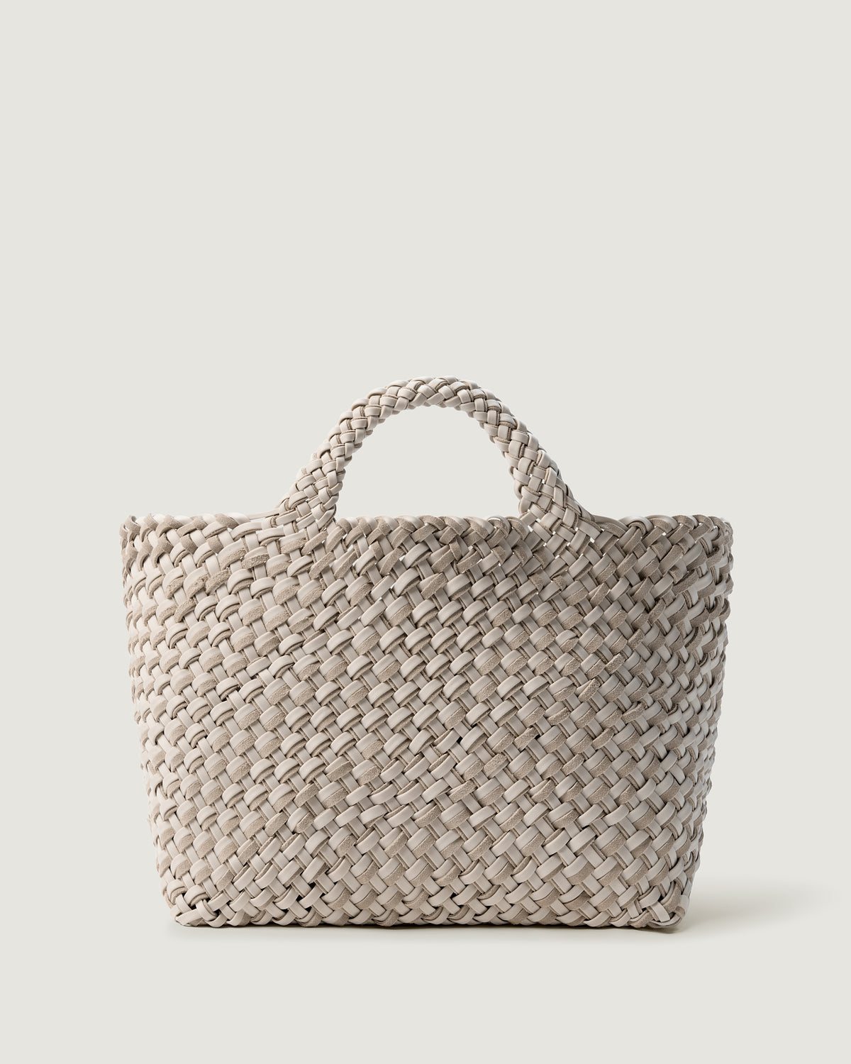 St. Barths Tote in Cerise, handwoven from doubled strands of ivory neoprene and suede. Featuring an open top and woven handles.