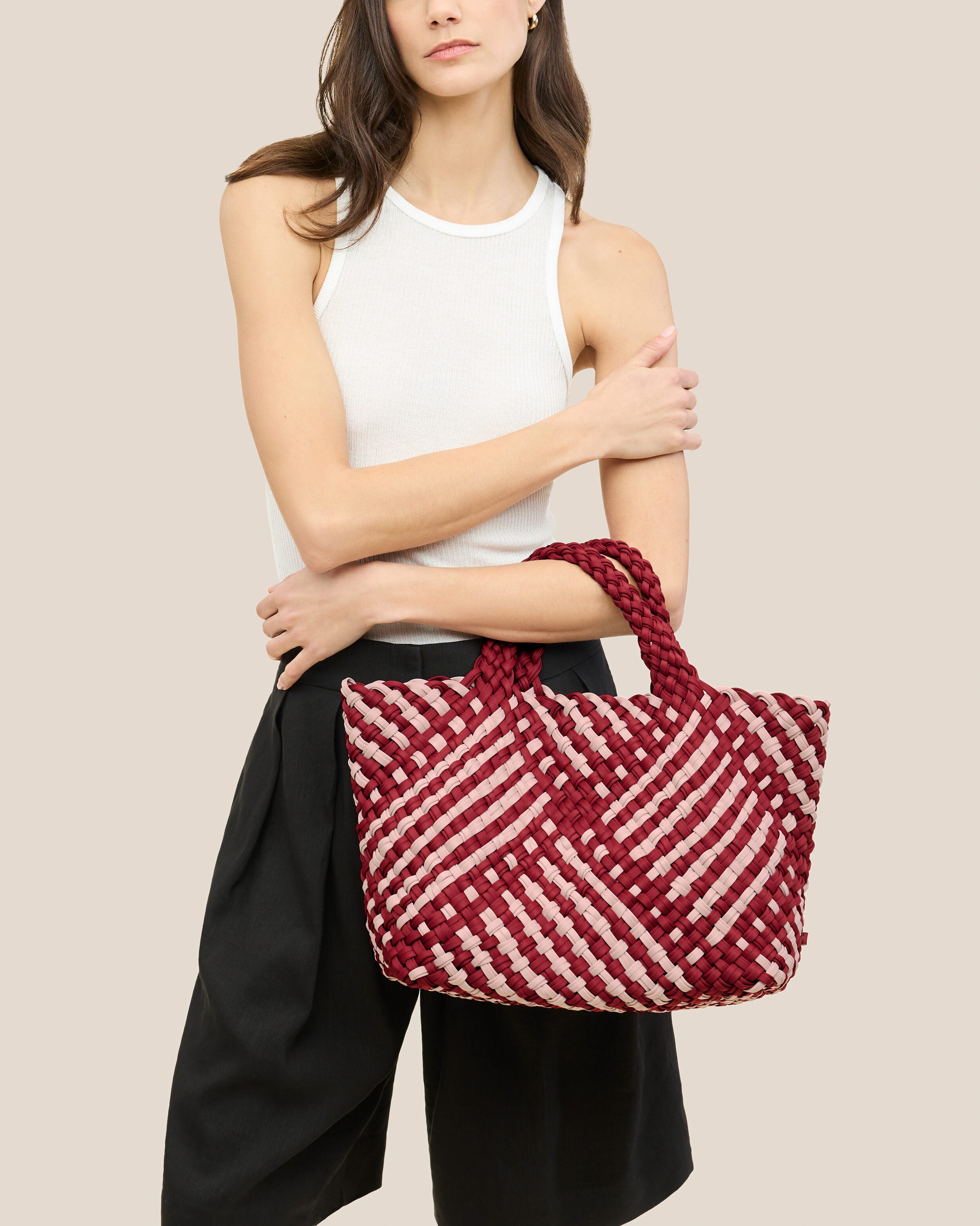 St. Barths Tote in Lychee shown on model to illustrate scale and soft silhouette.