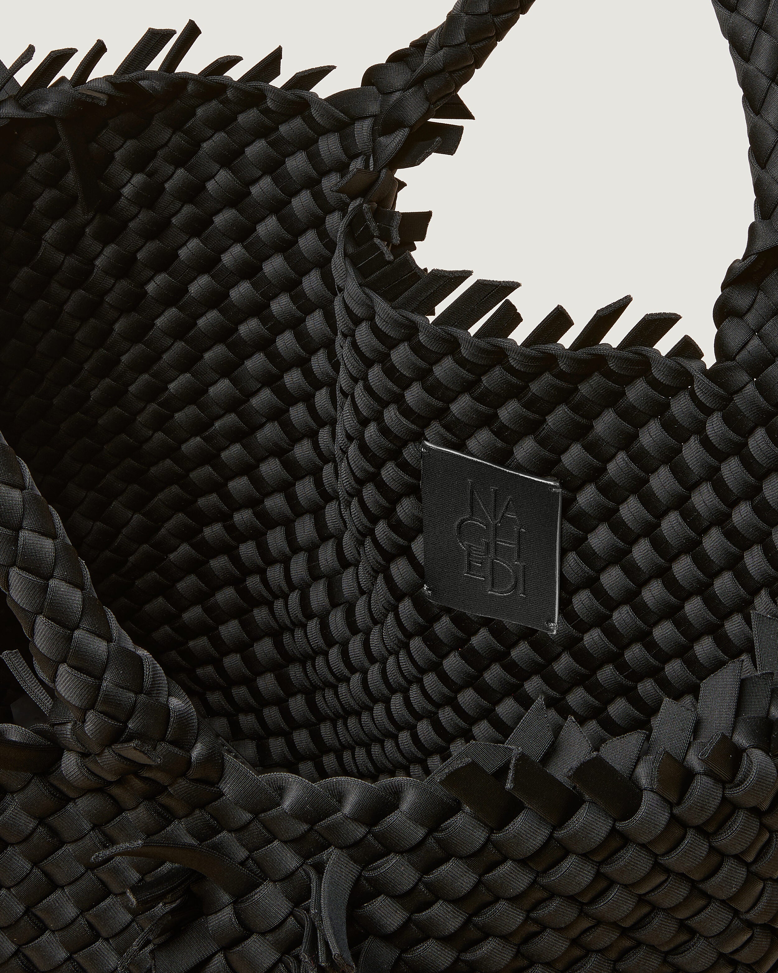 Interior close-up of St. Barths Tote in Onyx showing its open top, and unlined interior.