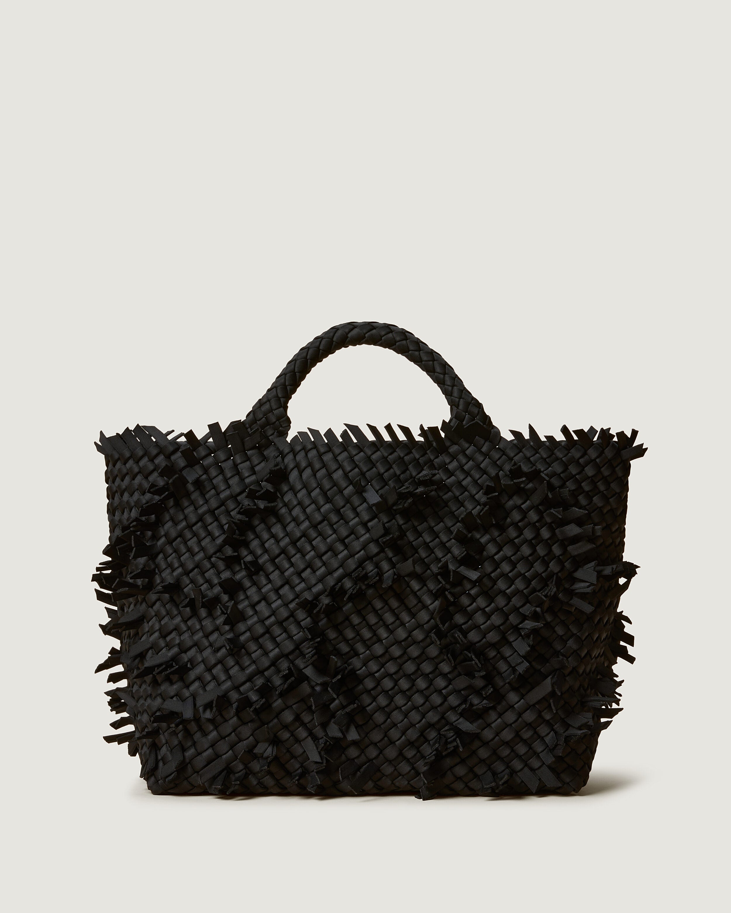 St. Barths Tote in Onyx, a true black tone, in handwoven neoprene, featuring an open top, and woven top handles.