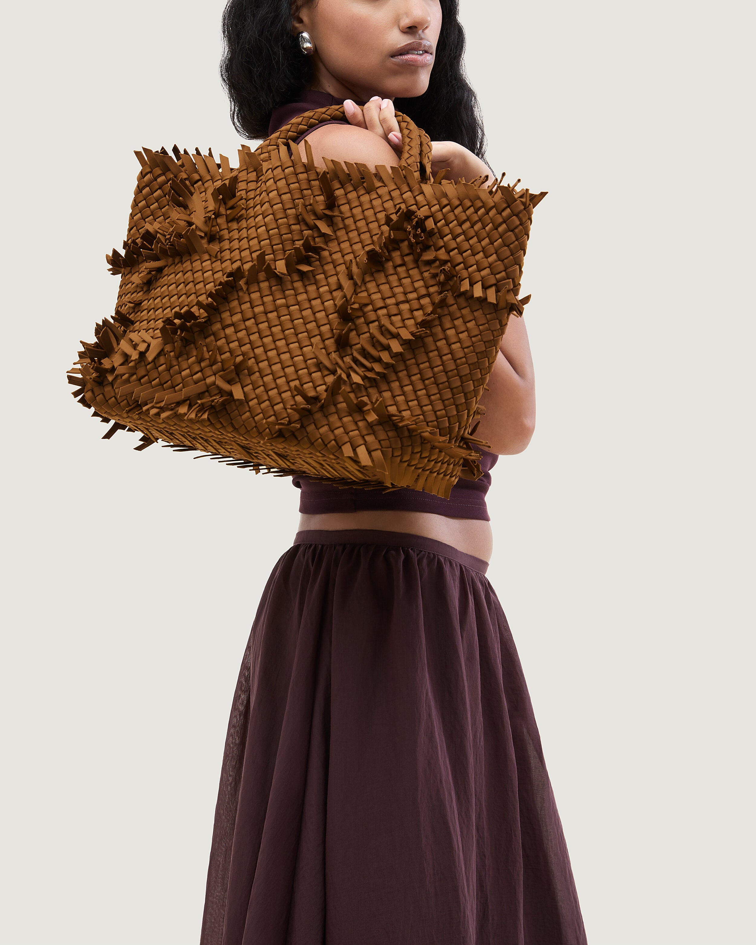 St. Barths Tote in Teak shown on model to illustrate scale and soft silhouette.