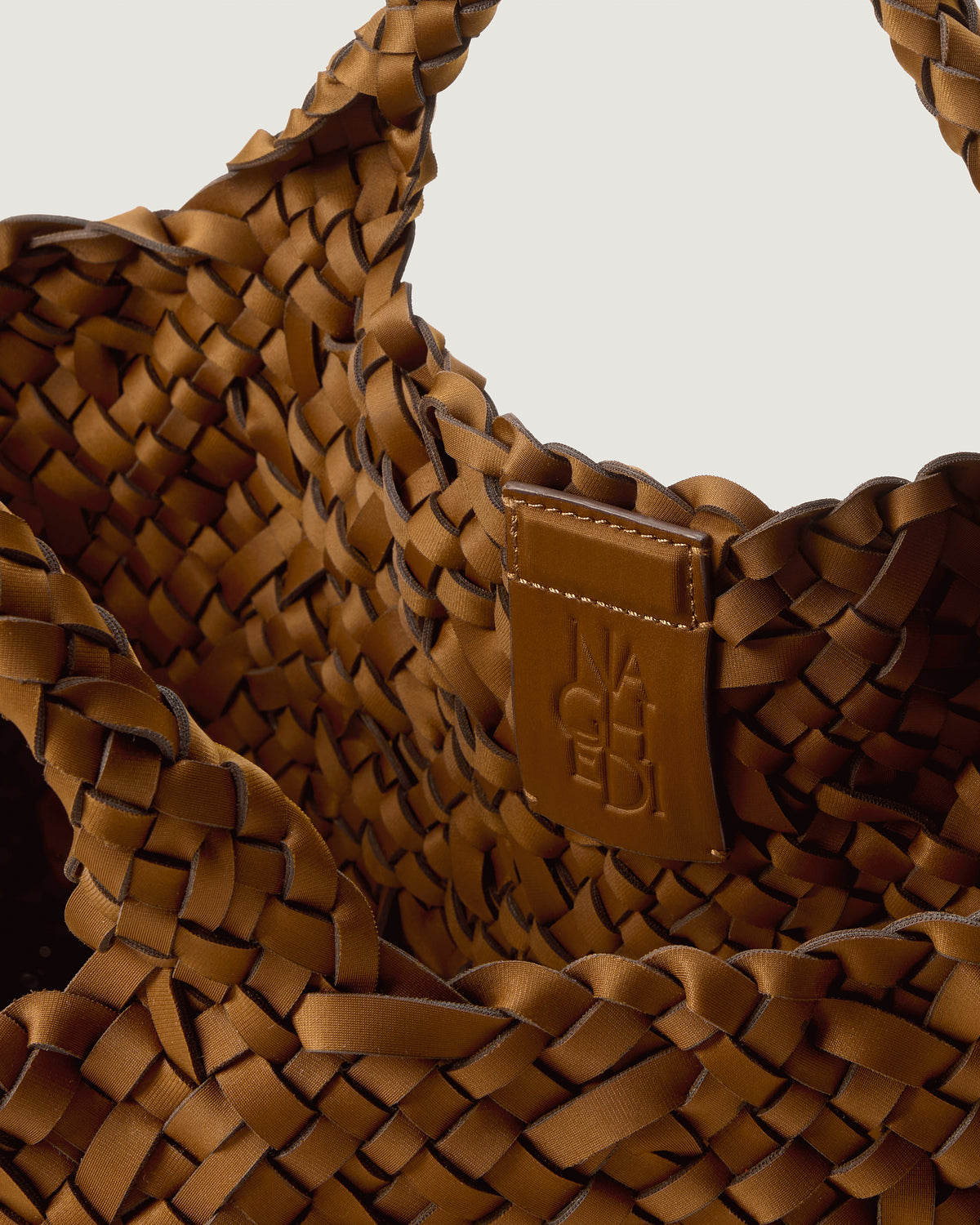 Interior close-up of St. Barths Tote in Teak showing its magnetic snap closure, and unlined interior.