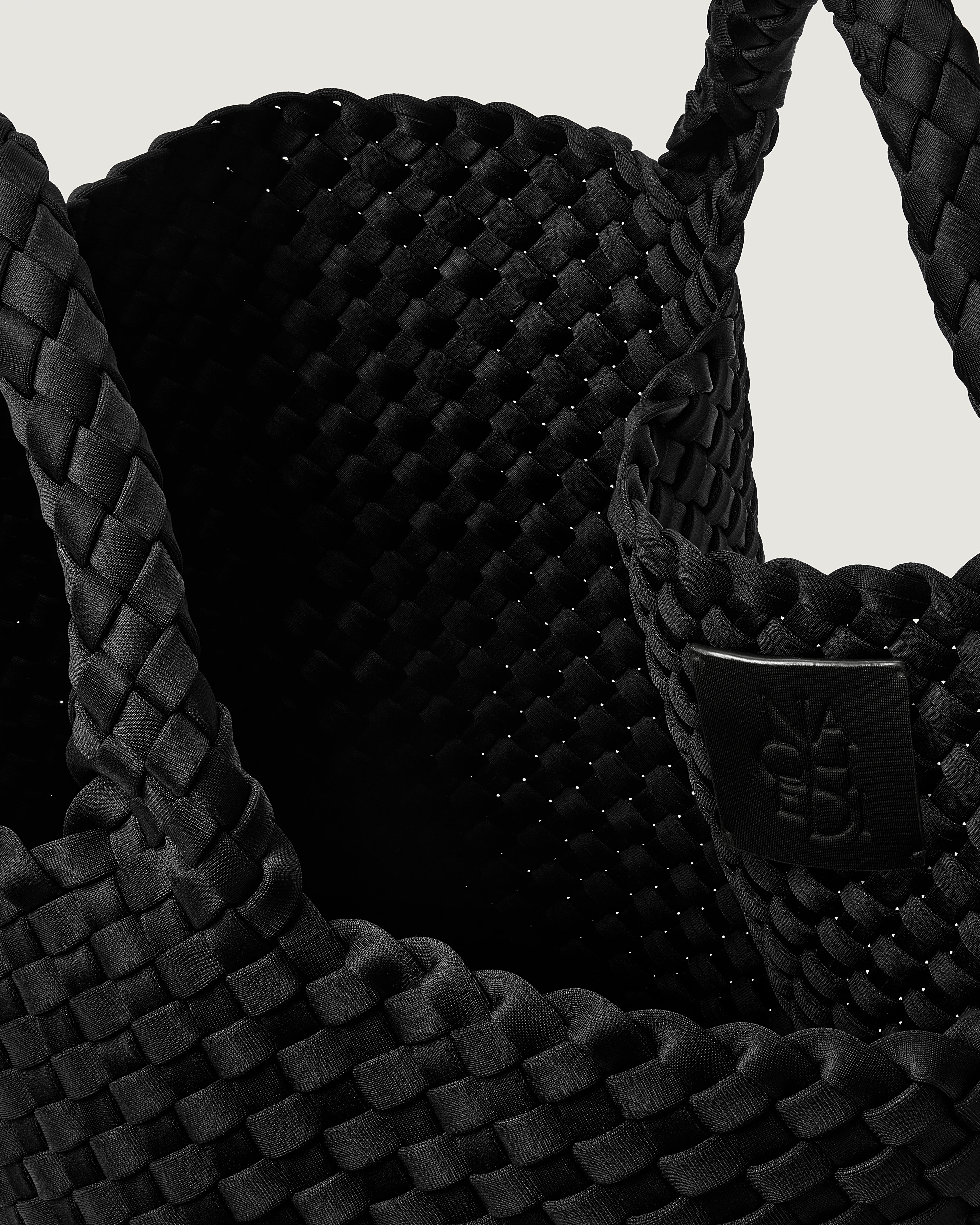 Interior close-up of St. Barths Tote in Onyx showing its open top, and unlined interior.