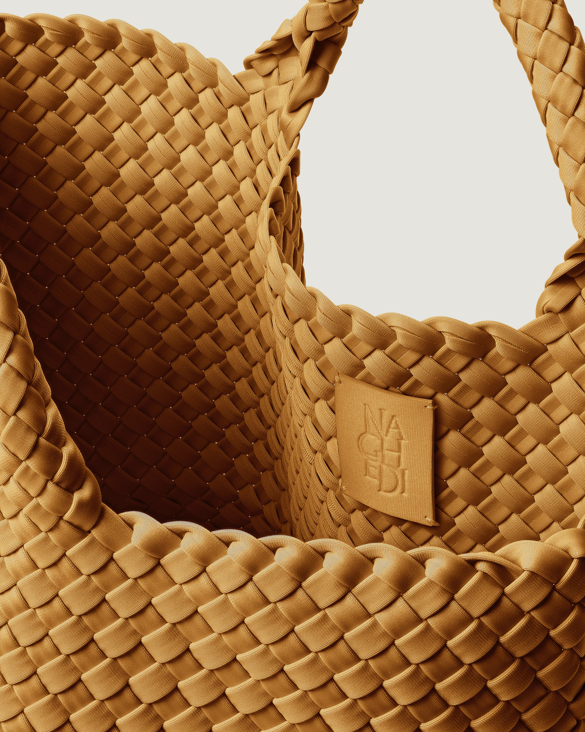 Interior close-up of St. Barths Tote in Turmeric showing its open top, and unlined interior.