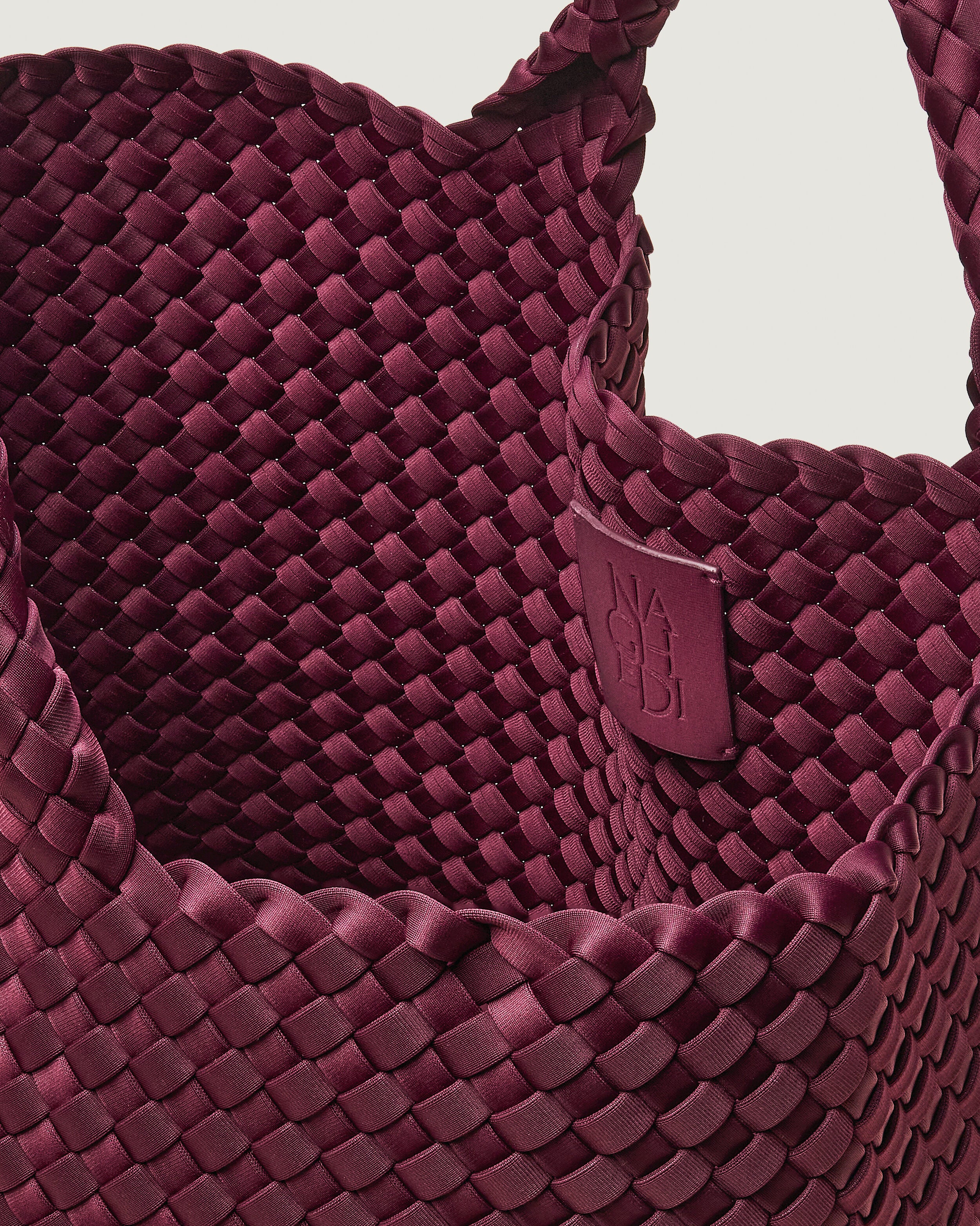 Interior close-up of St. Barths Tote in Bordeaux showing its open top, and unlined interior.